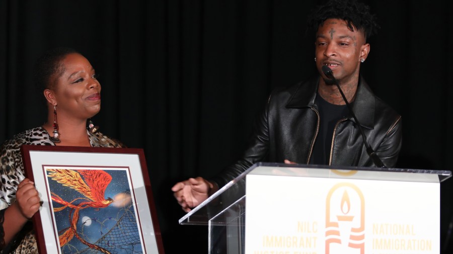 Patrisse Cullors, co-founder of Black Lives Matter presents 21 Savage with an award at the National Immigration Law Center's Courageous Luminaries Awards on Oct. 3, 2019 in Los Angeles. (Credit: Jerritt Clark/Getty Images for NILC)