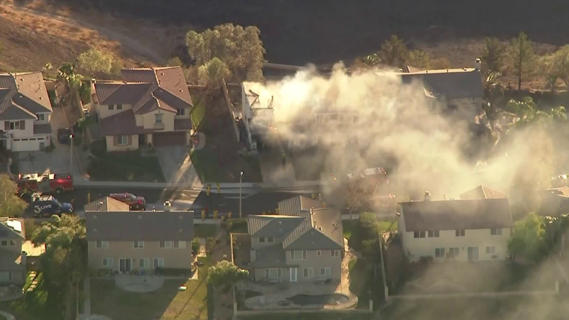 Smoke from a burning home lingers in the Santa Clarita Valley during the second day of the Tick Fire on Oct. 25, 2019. (Credit: KTLA)