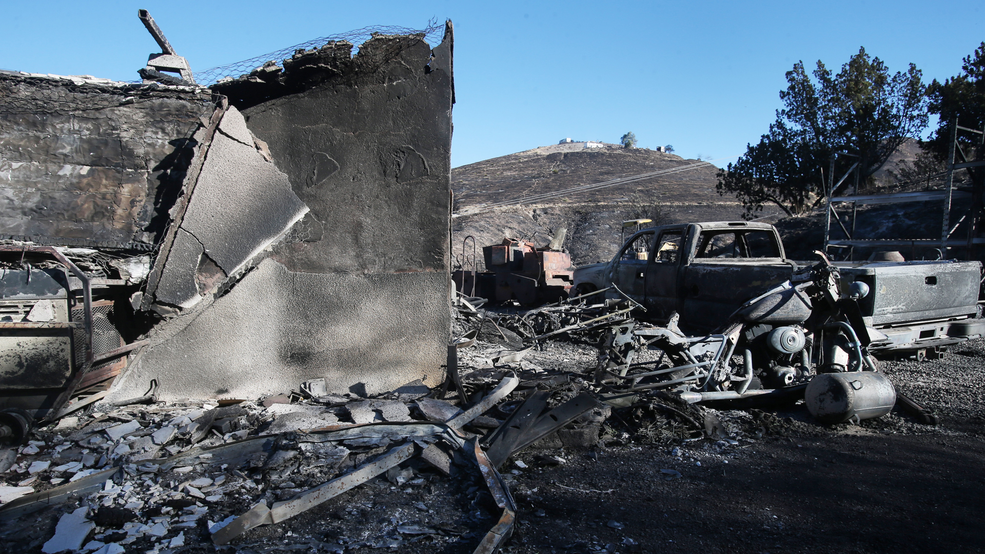 A structure and vehicle stand scorched by the Tick Fire on October 25, 2019 in Canyon Country, California. (Credit: Mario Tama/Getty Images)