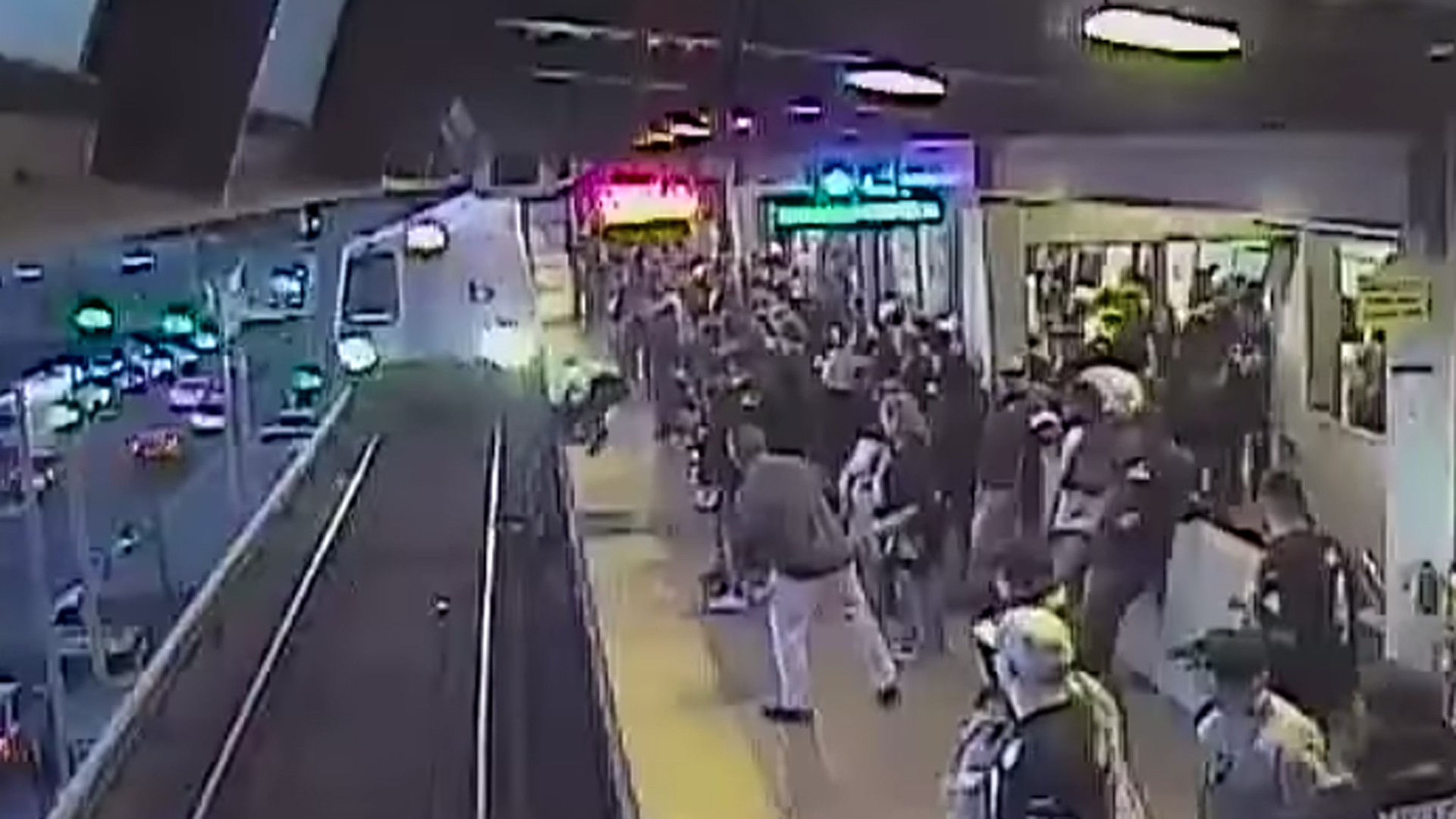 A still image of surveillance video showing an employee rescuing a man from BART tracks in Oakland on Nov. 3, 2019. (Credit: BART)