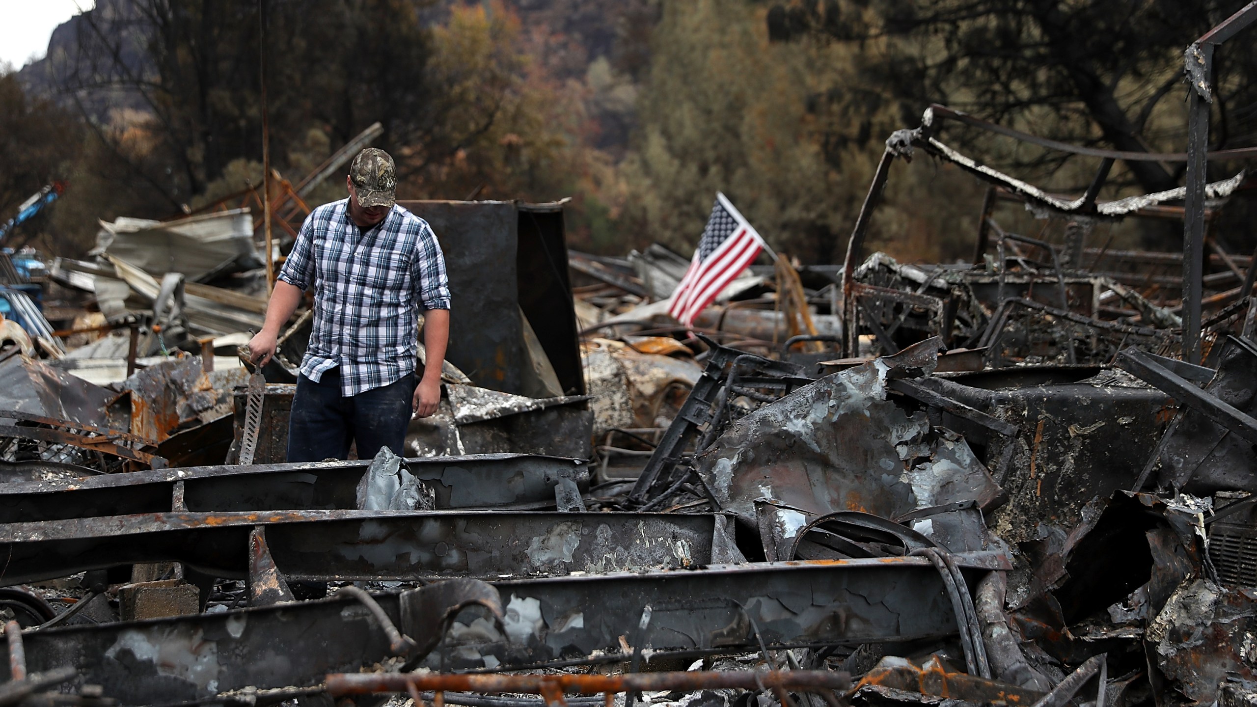 A man looks over his home that was destroyed by the Camp Fire on Nov. 22, 2018 in Paradise, California. (Credit: Justin Sullivan/Getty Images)