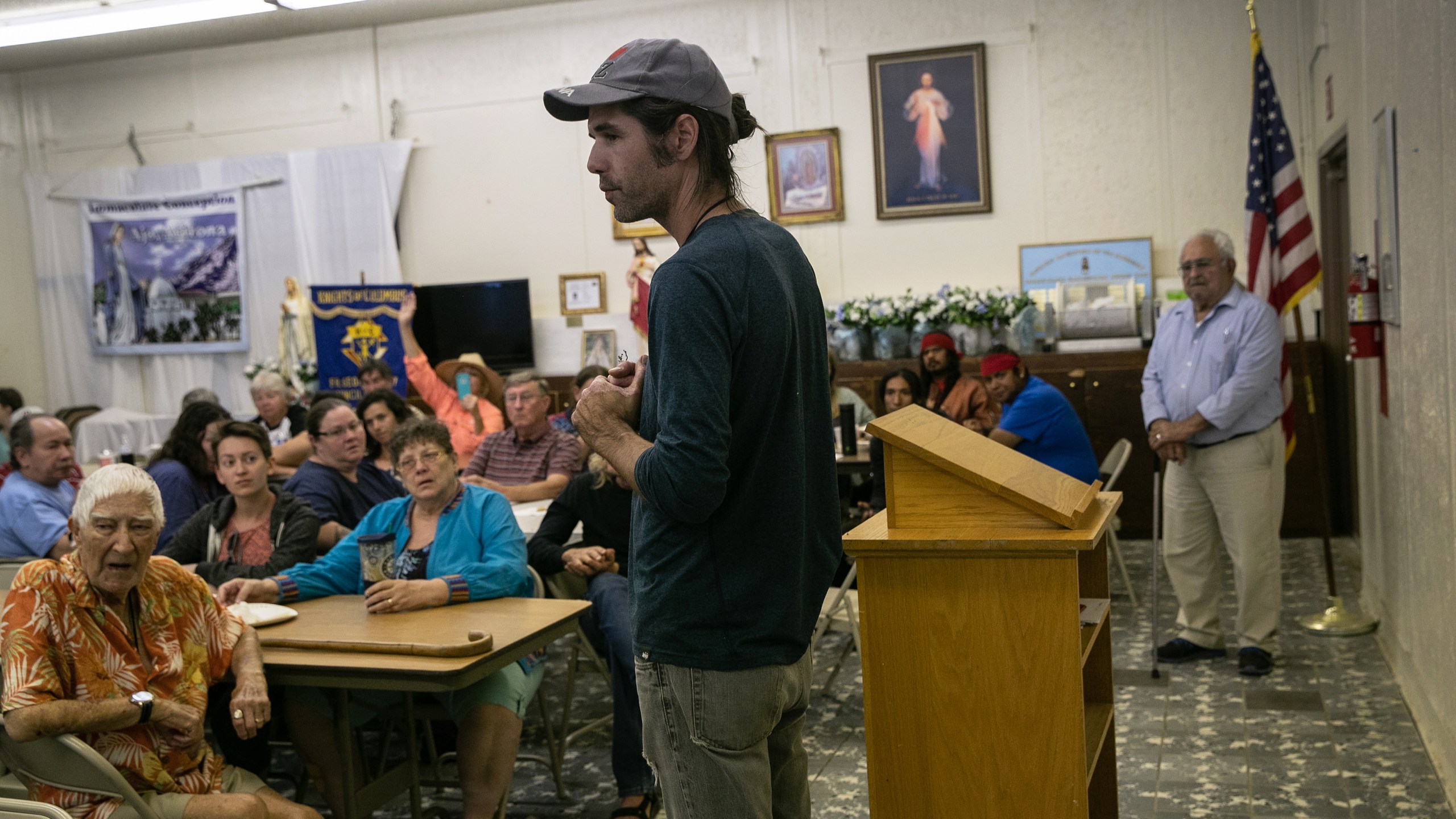 Scott Warren, a volunteer for the humanitarian aid organization No More Deaths, speaks with local residents during a community meeting to discuss federal charges against him for providing food and shelter to undocumented immigrants on May 10, 2019, in Ajo, Ariz. Warren was scheduled to appear in court for felony charges on May 29, in Tucson, accused by the U.S. government on two counts of harboring and one count of conspiracy for providing food, water, and beds to two Central American immigrants in January 2018. If found guilty, Warren could face up to 20 years in prison. (Credit: John Moore/Getty Images)