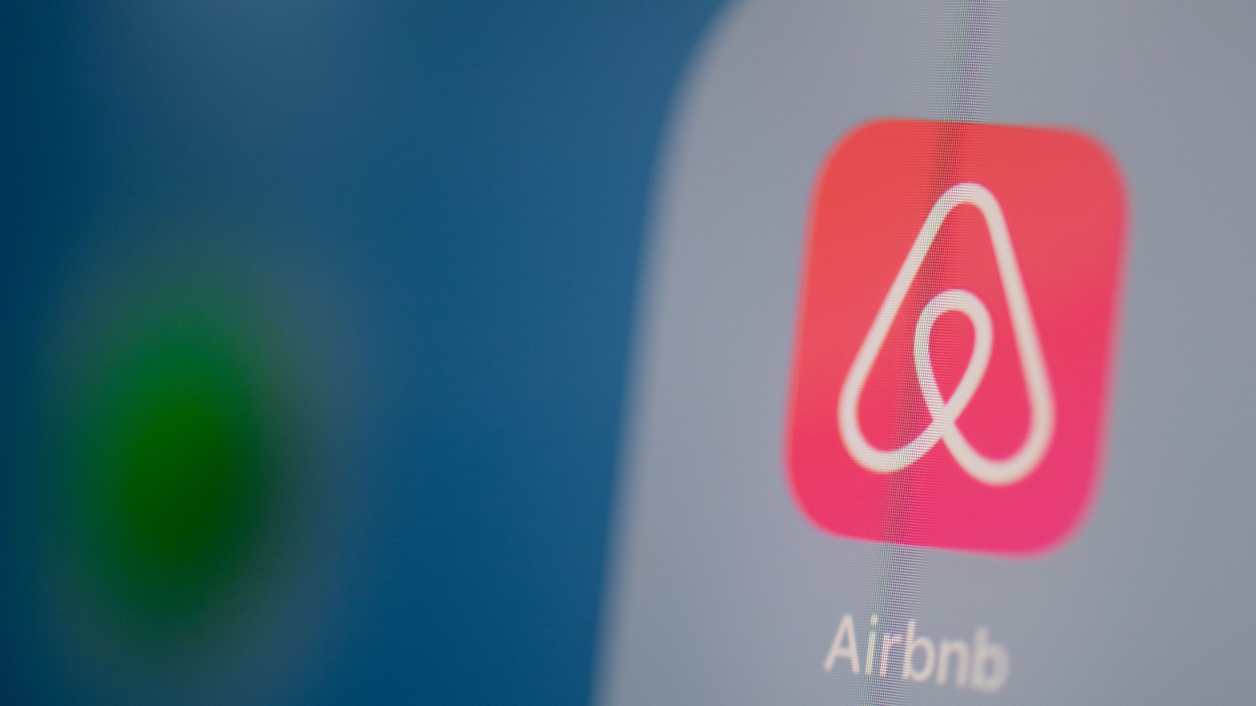 This illustration picture taken on July 24, 2019, in Paris shows the Airbnb logo on the screen of a tablet. (Credit: MARTIN BUREAU/AFP via Getty Images)