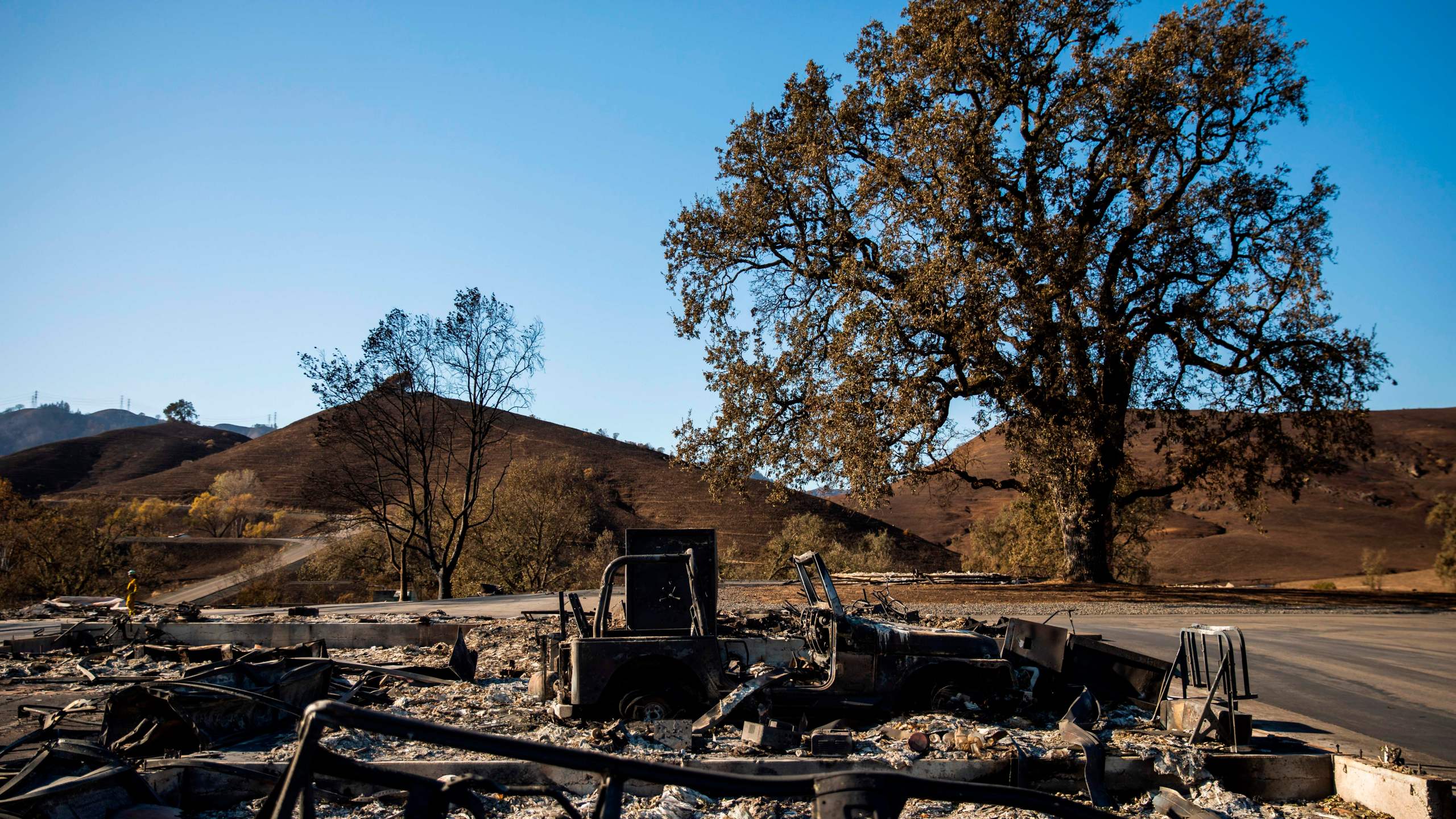 A burned vehicle sits on a property devastated by the Kincade Fire off Briggs Ranch Road in Kellogg on Oct. 31, 2019. (Credit: PHILIP PACHECO/AFP via Getty Images)