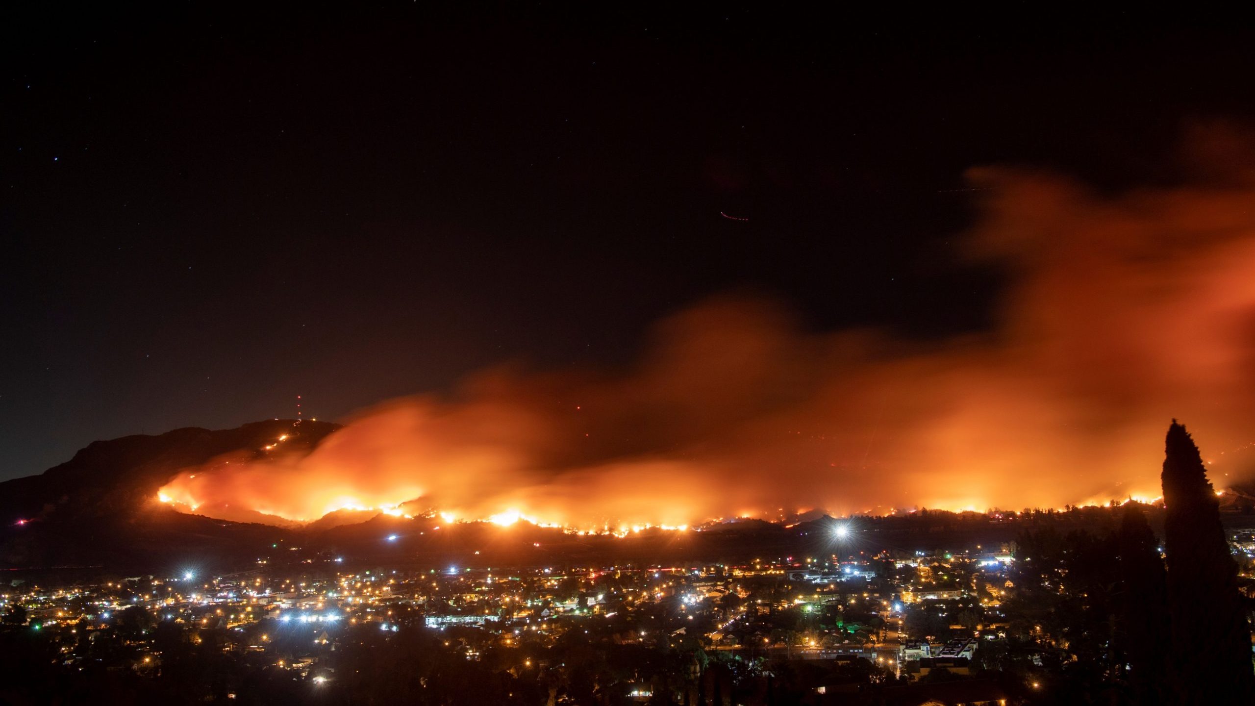 A long exposure photo shows the Maria Fire as it races across a hillside in Santa Paula on Nov. 1, 2019. (Credit: Josh Edelson / AFP via Getty Images)