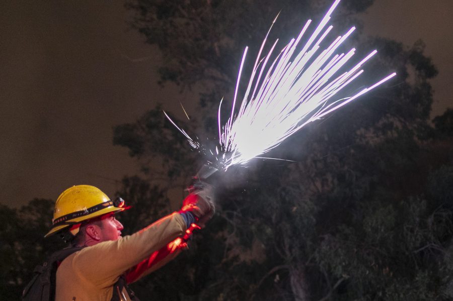 A firefighter shoots a flare gun to start a backfire at the Maria Fire on Nov. 1, 2019 near Somis. (Credit: David McNew/Getty Images)