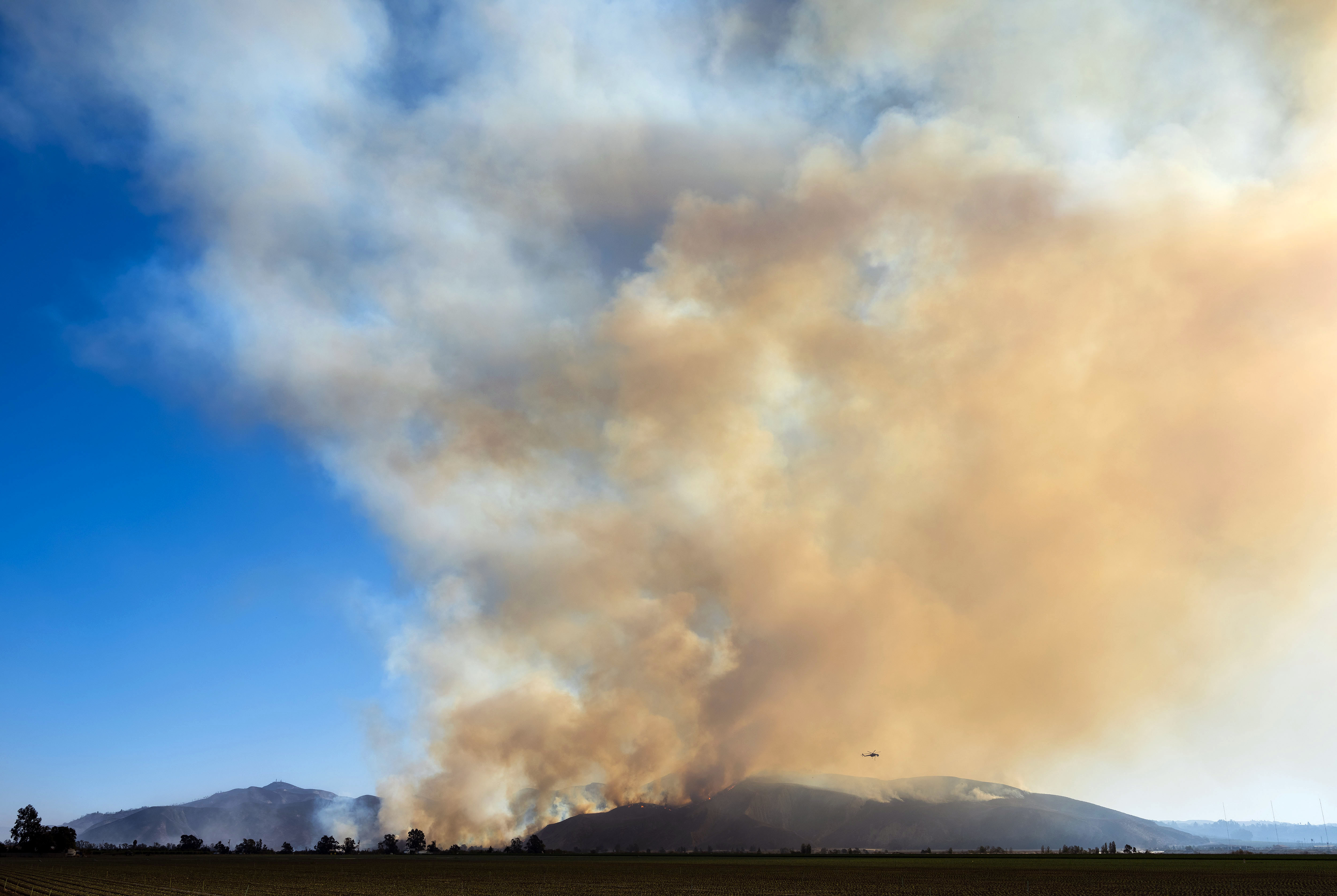 The Maria Fire is seen burning in the hills above the town of Santa Paula Oct. 31, 2019. in Ventura, California. (Credit: Brent Stirton/Getty Images)