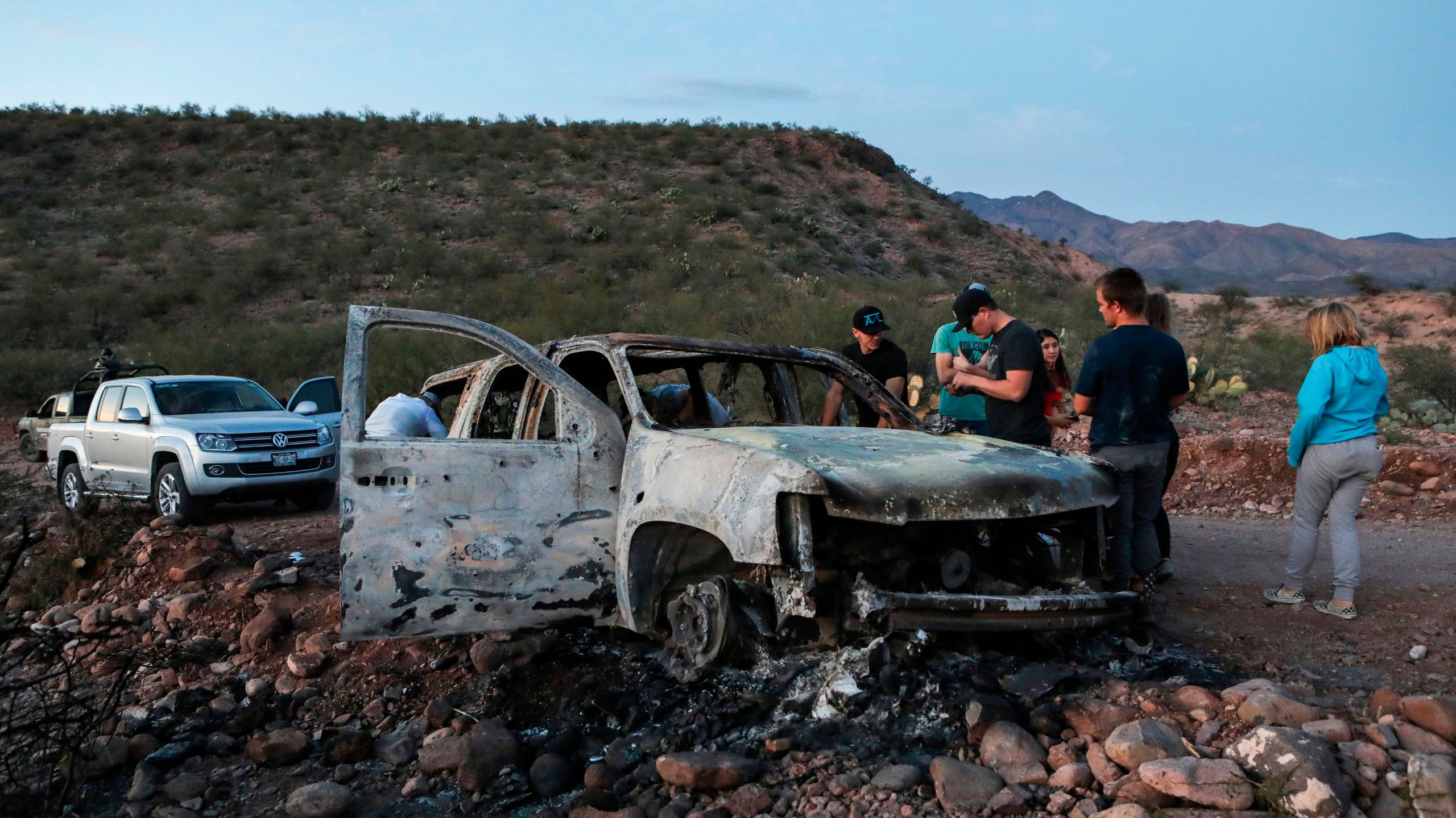 Members of the Lebaron family mourn as they look at the burned car where part of the nine murdered members of their family were killed and burned during an ambush in Bavispe, Sonora mountains, Mexico, on Nov.5, 2019. (Credit: HERIKA MARTINEZ/AFP via Getty Images)