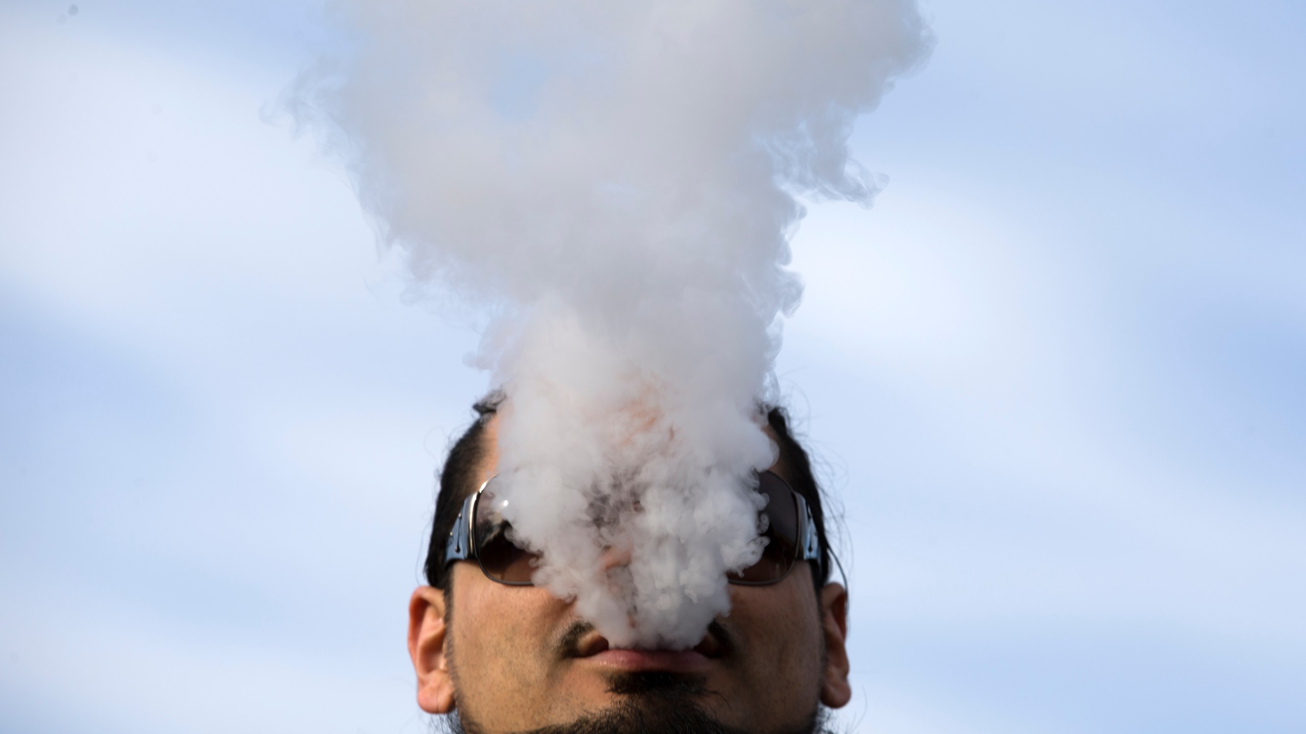 A demonstrator vapes during a rally outside the White House protesting a proposed vaping flavor ban on Nov. 9, 2019. (Credit: Jose Luis Magana / AFP / Getty Images)