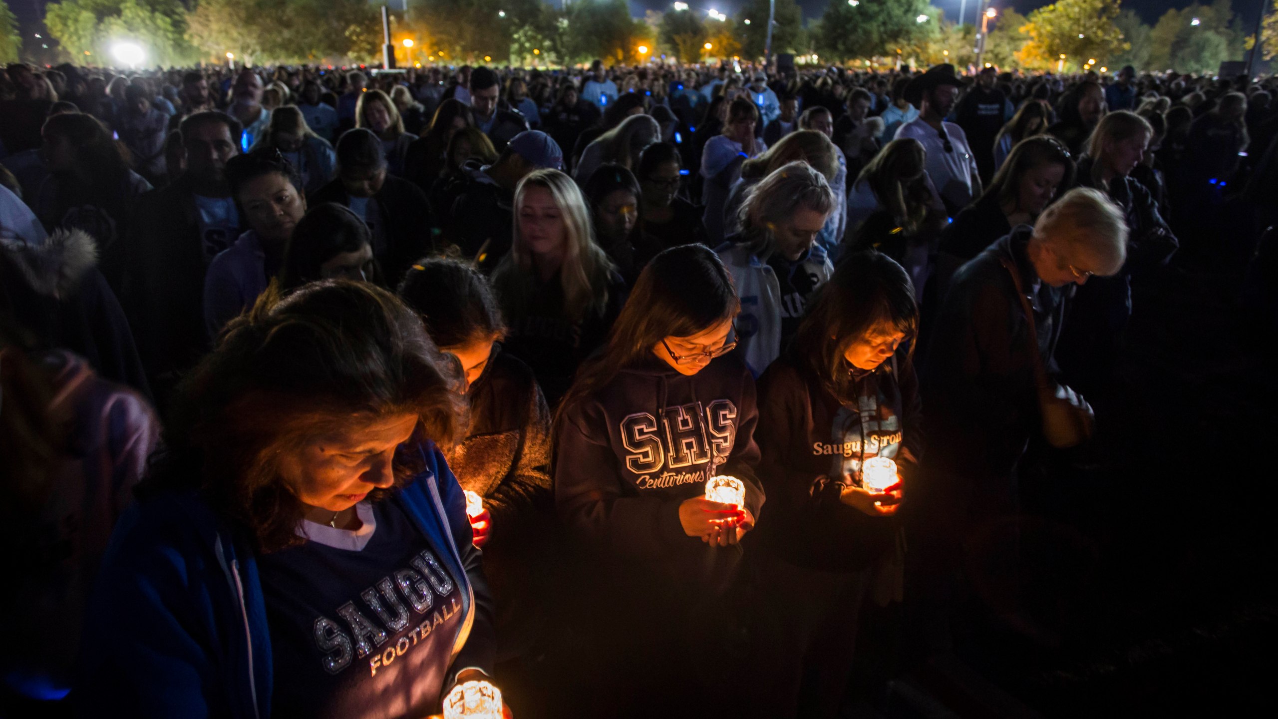 Mourners pray while holding candles at a vigil held for Saugus High School shooting victims on Nov. 17, 2019 in Santa Clarita. (Credit: Apu Gomes/Getty Images)