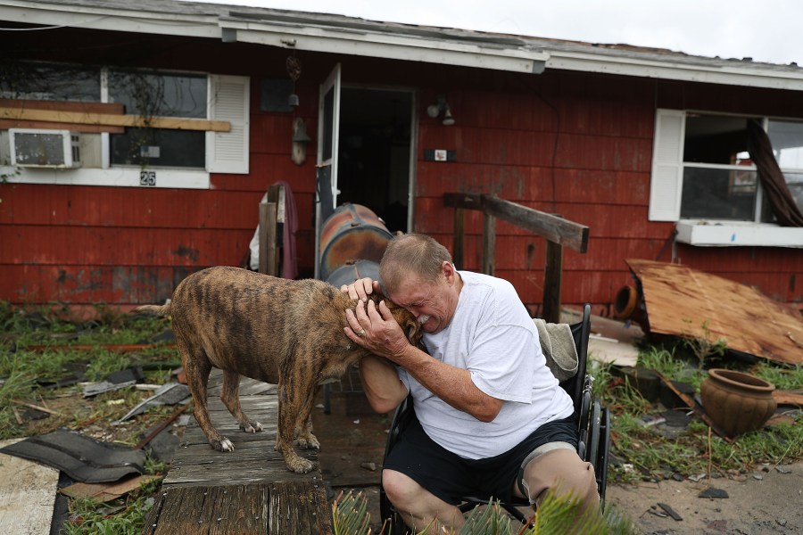 A man cries with his dog Otis after Hurricane Harvey destroyed most of his home on Aug. 26, 2017, in Rockport, Texas. (Credit: Joe Raedle/Getty Images)