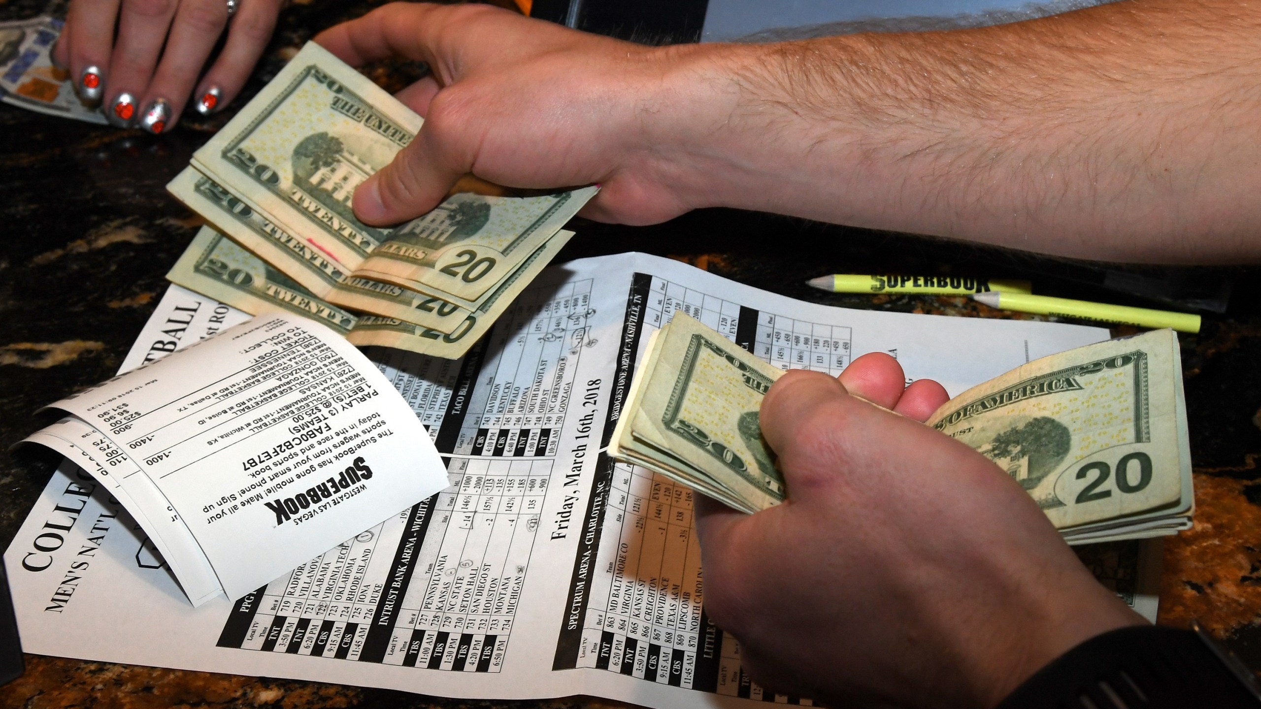 Jake Sindberg of Wisconsin makes bets during a viewing party for the NCAA Men's College Basketball Tournament inside the Westgate Las Vegas Resort & Casino in Las Vegas on March 15, 2018. (Credit: Ethan Miller / Getty Images)