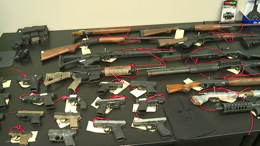 Some of the confiscated firearms in a gang takedown in Stockton are seen at a news conference on Nov. 19, 2019. (Credit: KTXL)