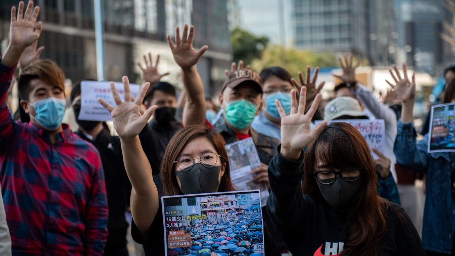 People gather in support of pro-democracy protesters during a lunch break rally in the Kwun Tong area in Hong Kong on November 27, 2019. (Credit: Nicolas Asfouri/AFP/Getty Images)