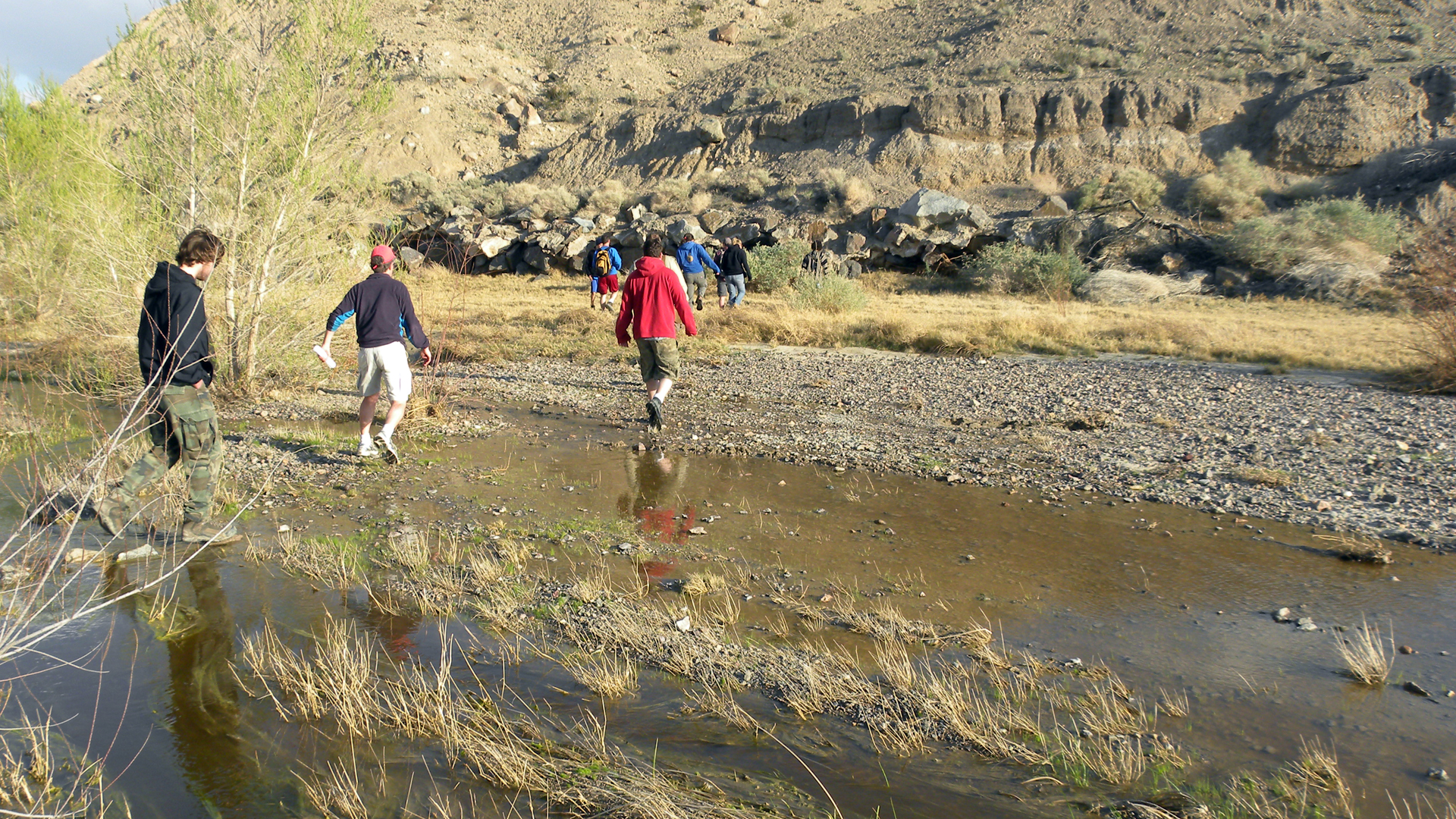 People walk across the Mojave River near Afton Canyon in March 2010. (Credit: Mark A. Wilson / Wikimedia Commons)