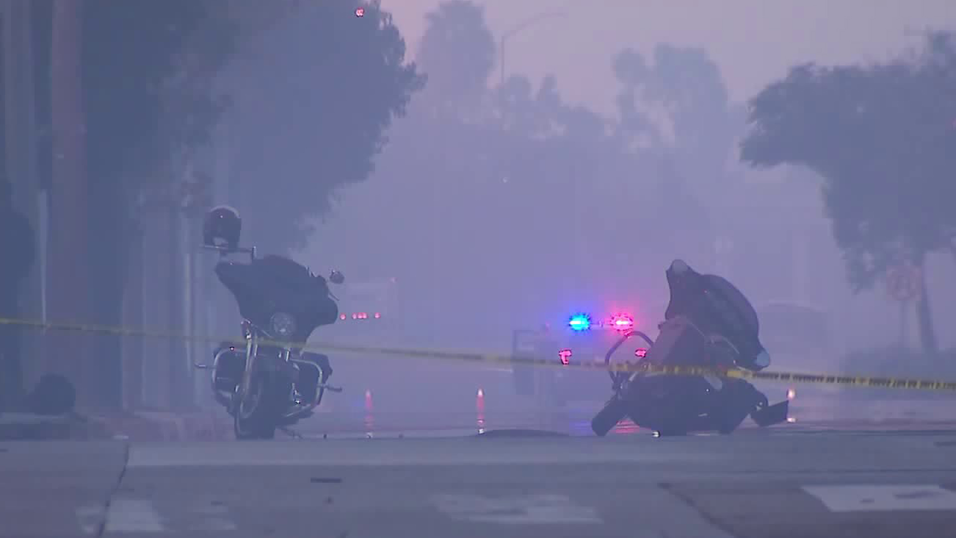 Two motorcycles lie in the middle of the road in Carson after three riders were shot at nearby on Nov. 3, 2019. (Credit: KTLA)