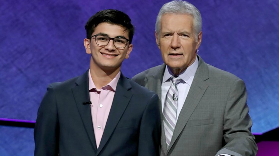 Avi Gupta poses with Alex Trebek in this 2019 photo. (Credit: Jeopardy Productions Inc. via CNN)