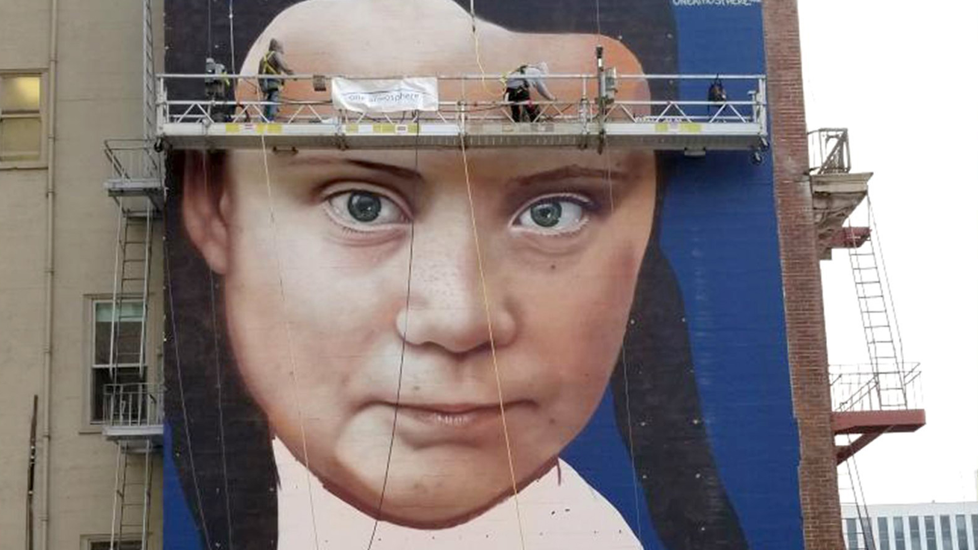 Artists work on a mural of Swedish teenage climate activist, Greta Thunberg, in San Francisco. (Credit: Courtesy One Atmosphere via CNN)