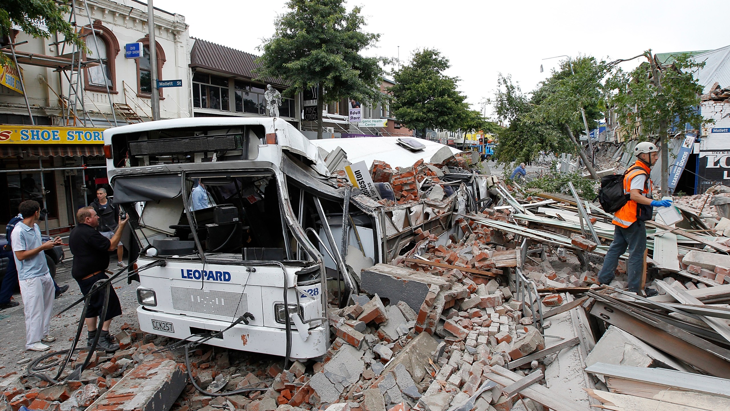 A bus covered in building debris is seen on February 22, 2011 in Christchurch, New Zealand. (Credit: Martin Hunter/Getty Images)