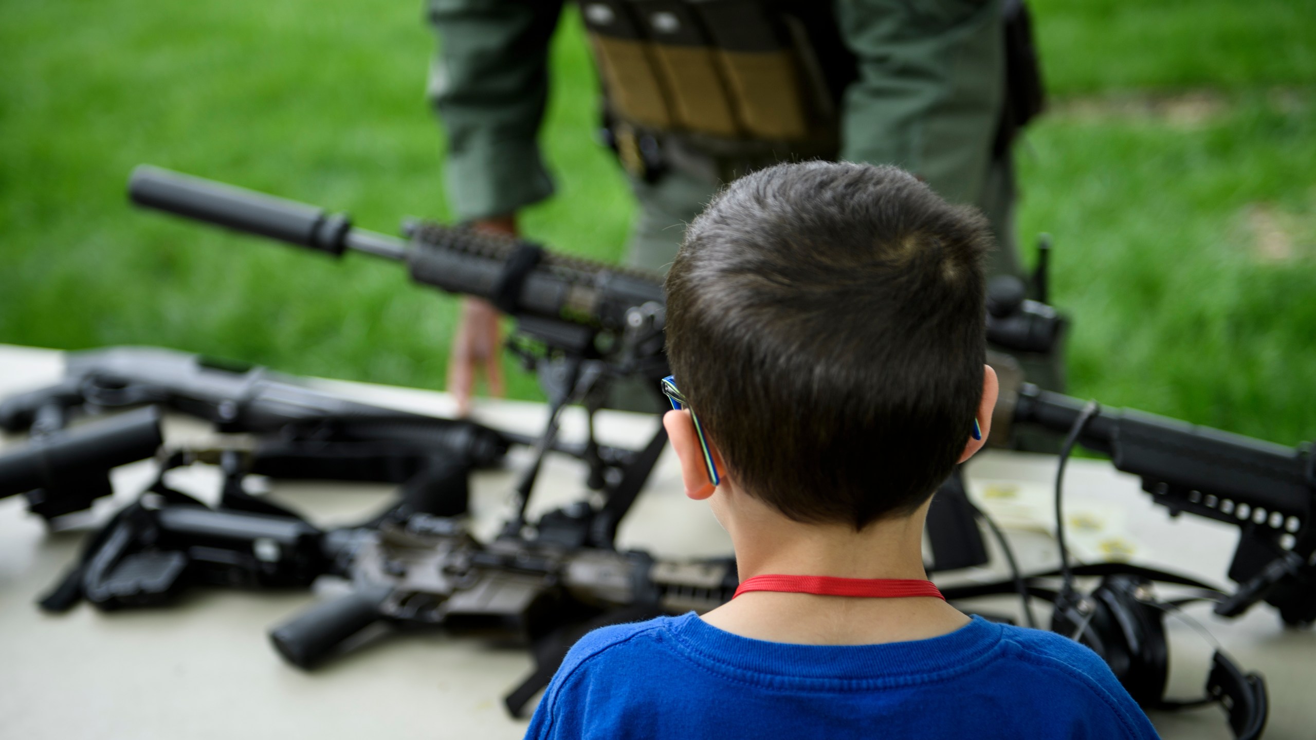 A child looks at a rifle during a demonstration for "Take Your Child to Work Day" at the Pentagon April 25, 2019, in Washington, D.C. (Credit: BRENDAN SMIALOWSKI/AFP via Getty Images)