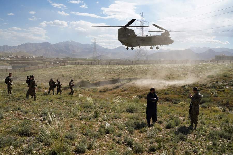 In this photo taken on June 6, 2019, a U.S. military Chinook helicopter lands on a field outside the governor's palace during a visit by the commander of U.S. and NATO forces in Afghanistan. (Credit: THOMAS WATKINS/AFP via Getty Images)