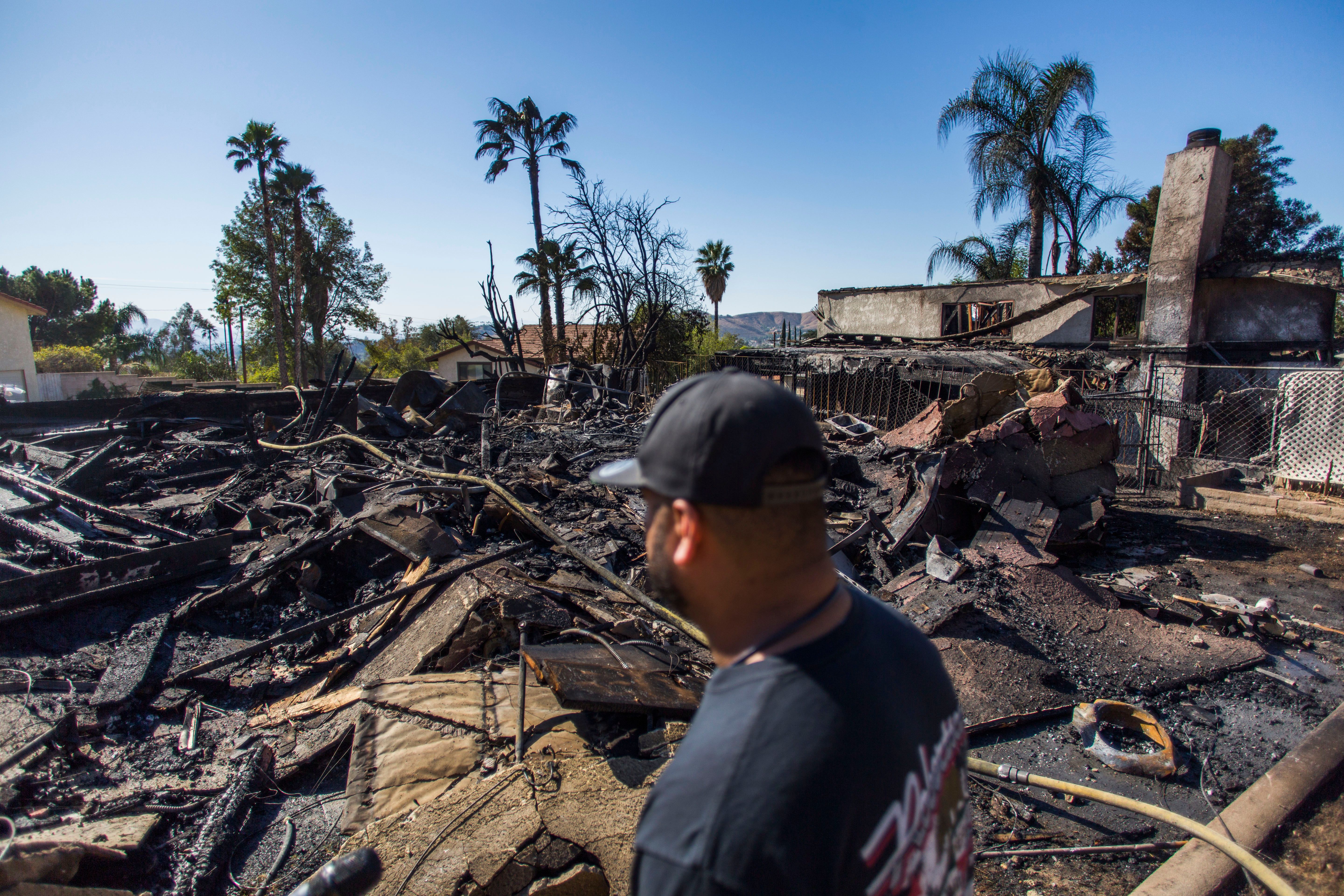 Matthew Valdivia looks at what is left of his home on Viento Way after it was destroyed by the Hillside Fire in San Bernardino, Oct. 31, 2019. (Credit: Apu Gomes / AFP / Getty Images)