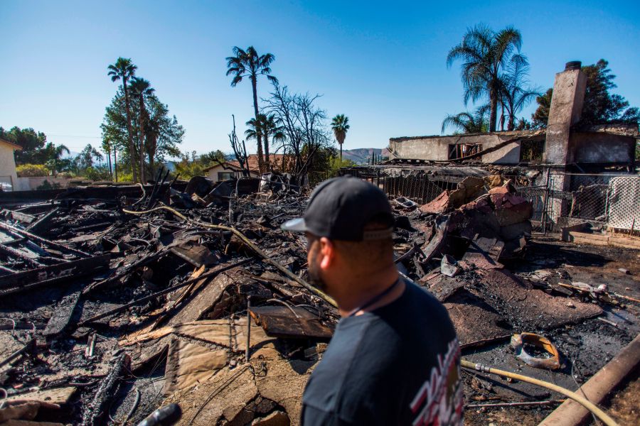 Matthew Valdivia looks at what is left of his home on Viento Way after it was destroyed by the Hillside Fire in San Bernardino, Oct. 31, 2019. (Credit: Apu Gomes / AFP / Getty Images)