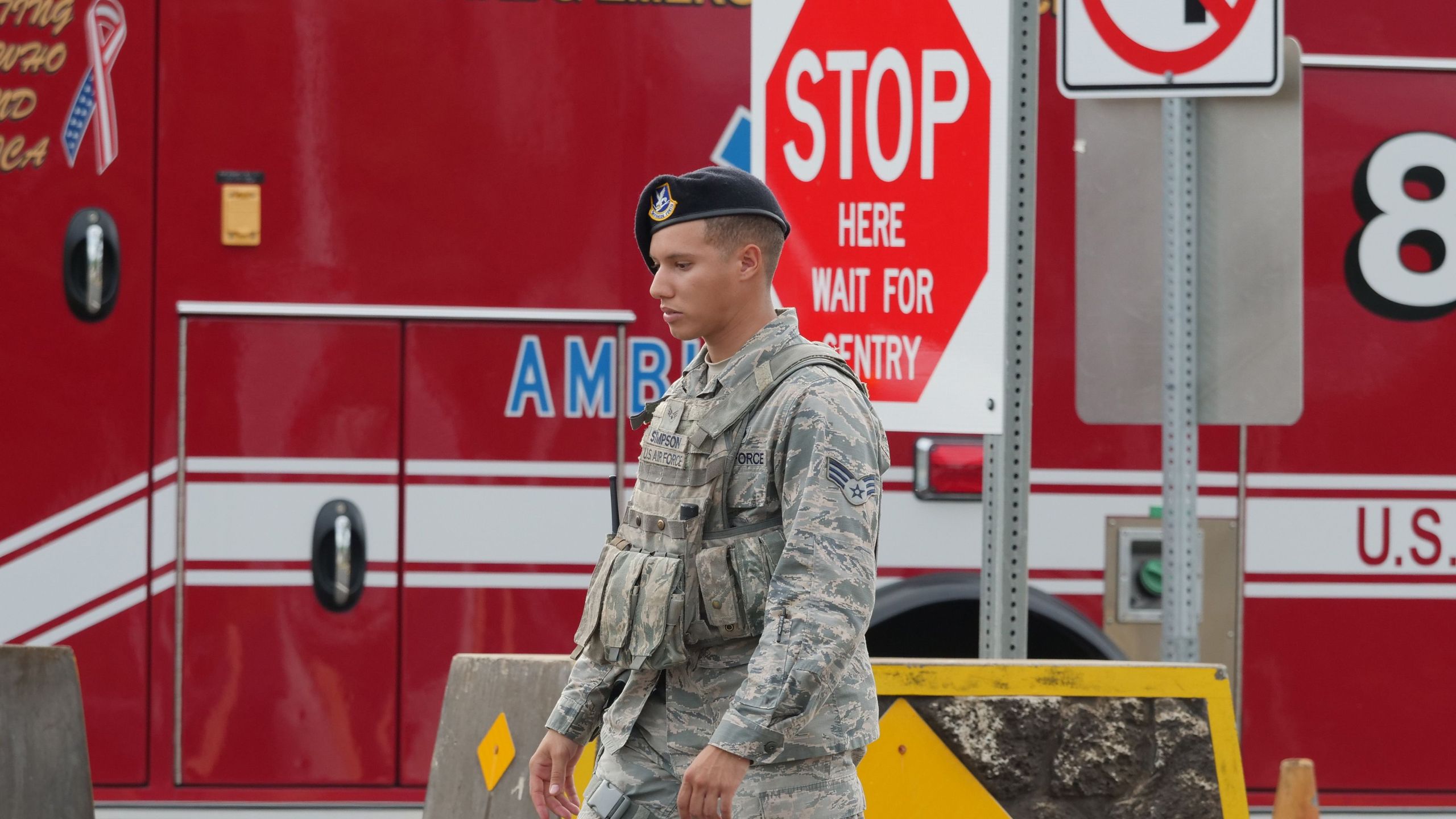 A security guard walks past a naval emergency ambulance responding to a fatal shooting at the Pearl Harbor Naval Shipyard, in Honolulu, Hawaii on December 4, 2019. (Credit: RONEN ZILBERMAN/AFP via Getty Images)