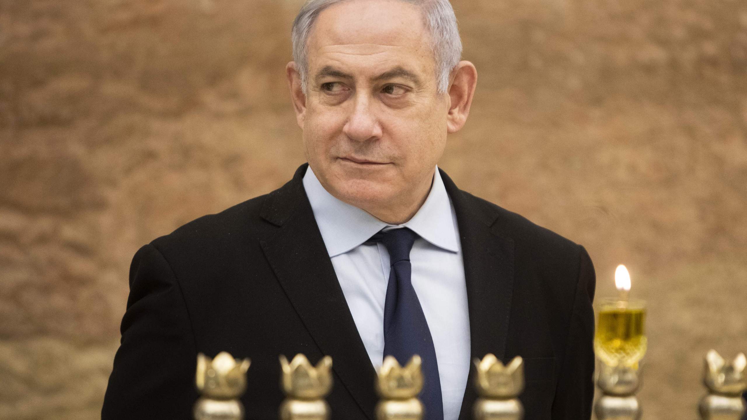 Israeli Prime Minister Benjamin Netanyahu looks on after lighting a Hanukkah candle at the Western Wall, Judaism's holiest prayer site, in the Old City of Jerusalem on Dec. 22, 2019. (Credit: SEBASTIAN SCHEINER/POOL/AFP via Getty Images)