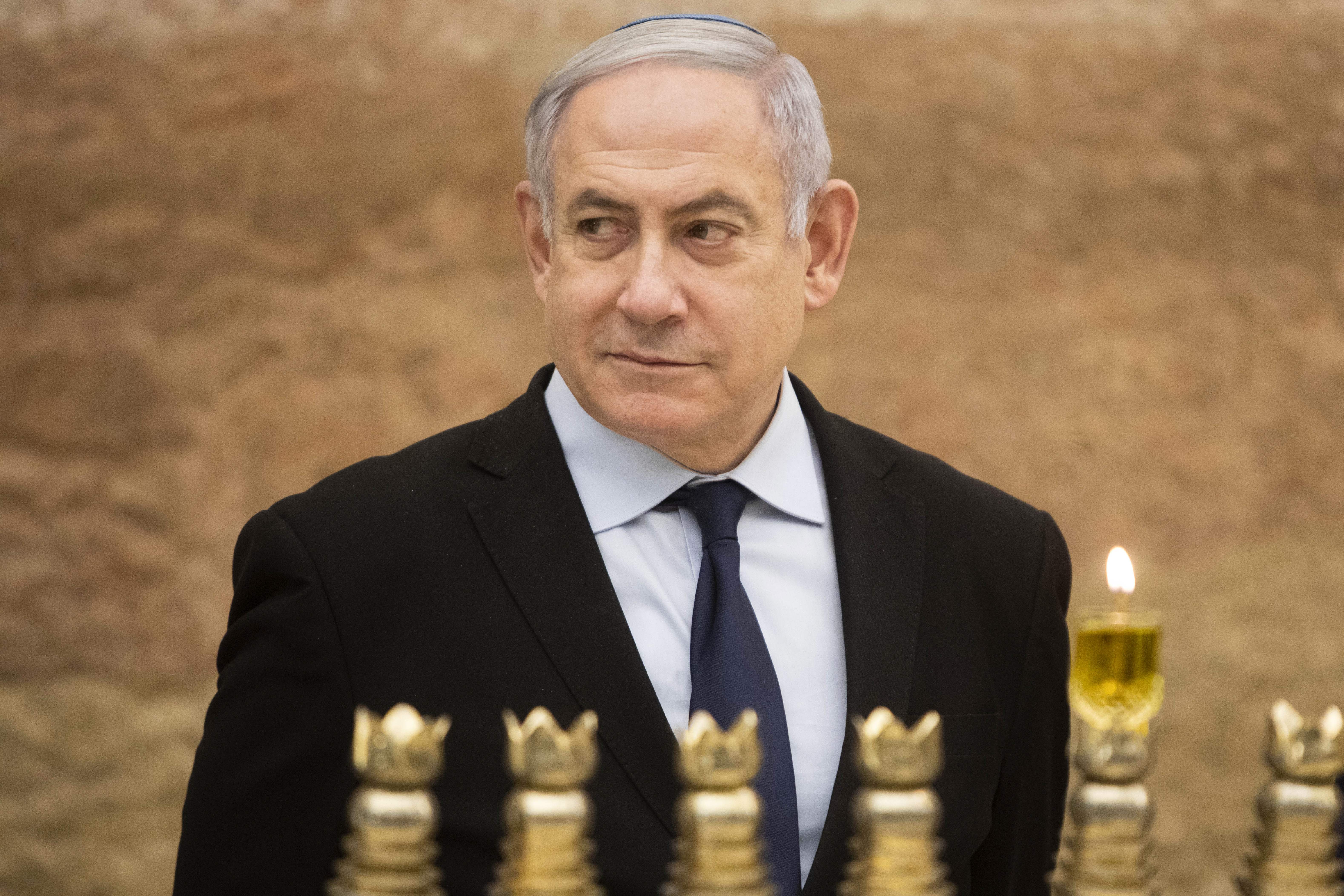 Israeli Prime Minister Benjamin Netanyahu looks on after lighting a Hanukkah candle at the Western Wall, Judaism's holiest prayer site, in the Old City of Jerusalem on Dec. 22, 2019. (Credit: SEBASTIAN SCHEINER/POOL/AFP via Getty Images)