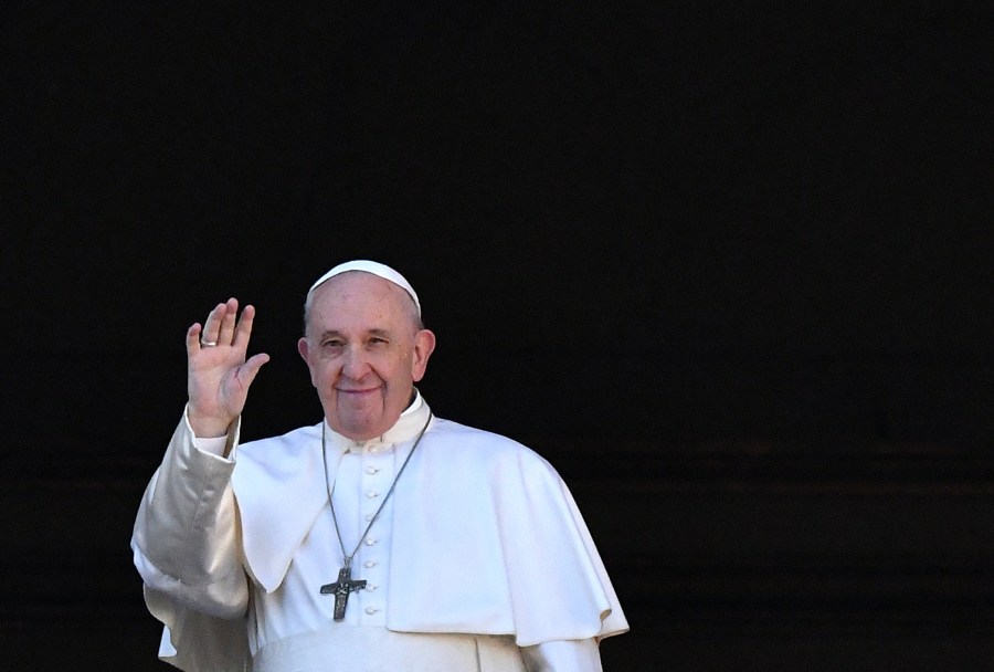 Pope Francis waves from the balcony of St. Peter's Basilica during the traditional "Urbi et Orbi" Christmas message to the city and the world, on Dec. 25, 2019 at St Peter's Square in the Vatican. (Credit: ALBERTO PIZZOLI/AFP via Getty Images)