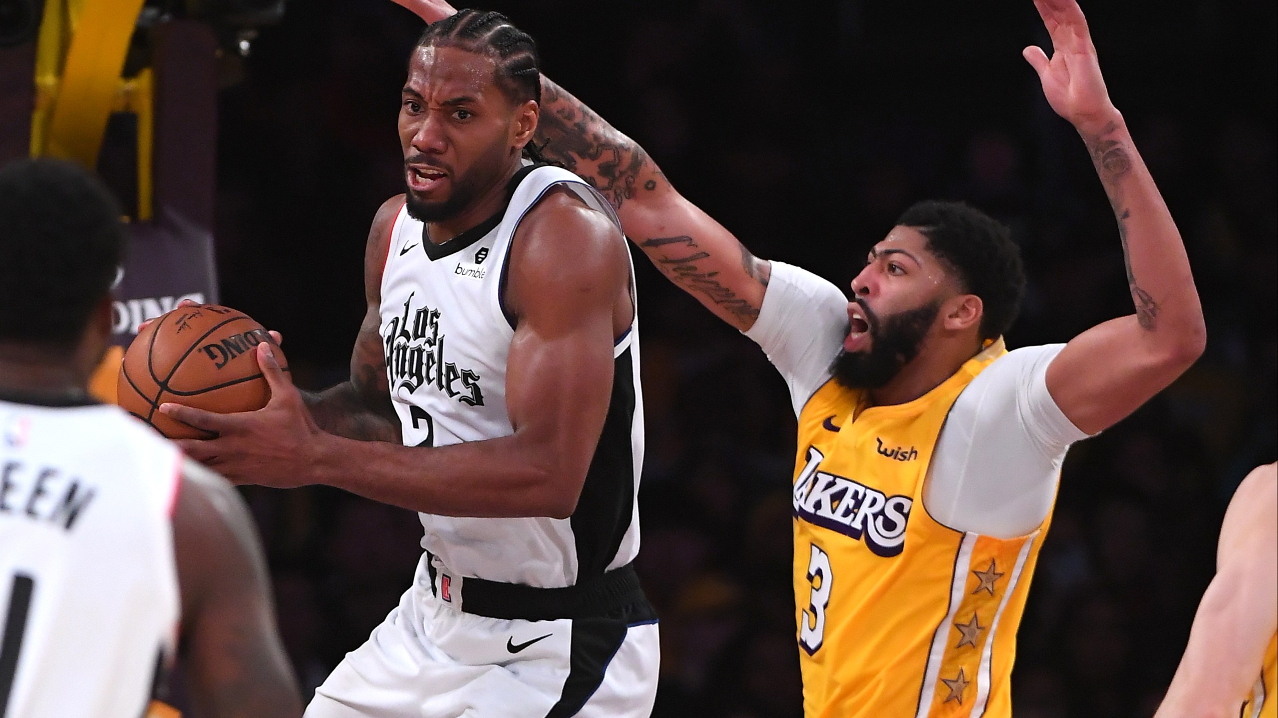 Anthony Davis #3 of the Los Angeles Lakers defends guards Kawhi Leonard #2 of the Los Angeles Clippers as he makes a pass under the basket in the second half of the game at Staples Center on Dec. 25, 2019. (Credit: Jayne Kamin-Oncea/Getty Images)