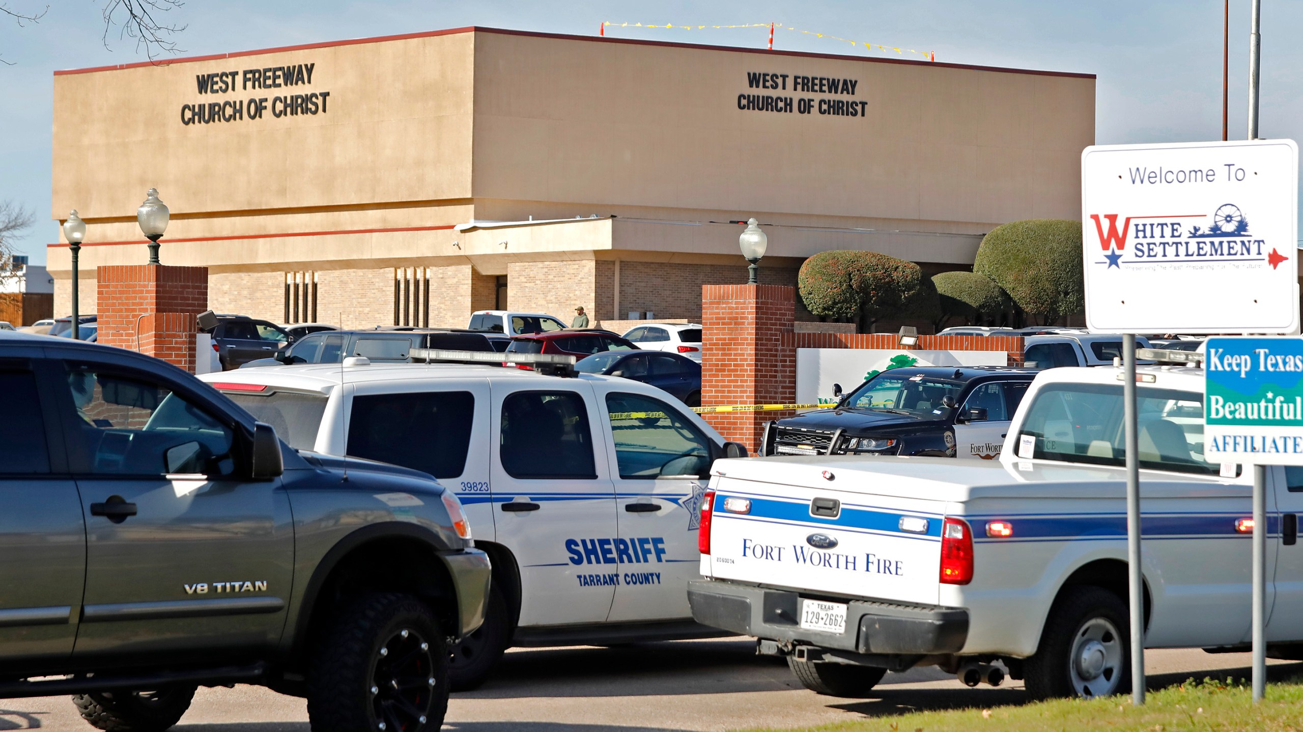 Law enforcement vehicles are parked outside West Freeway Church of Christ where a shooting took place at the morning service on Dec. 29, 2019, in White Settlement, Texas. (Credit: Stewart F. House/Getty Images)