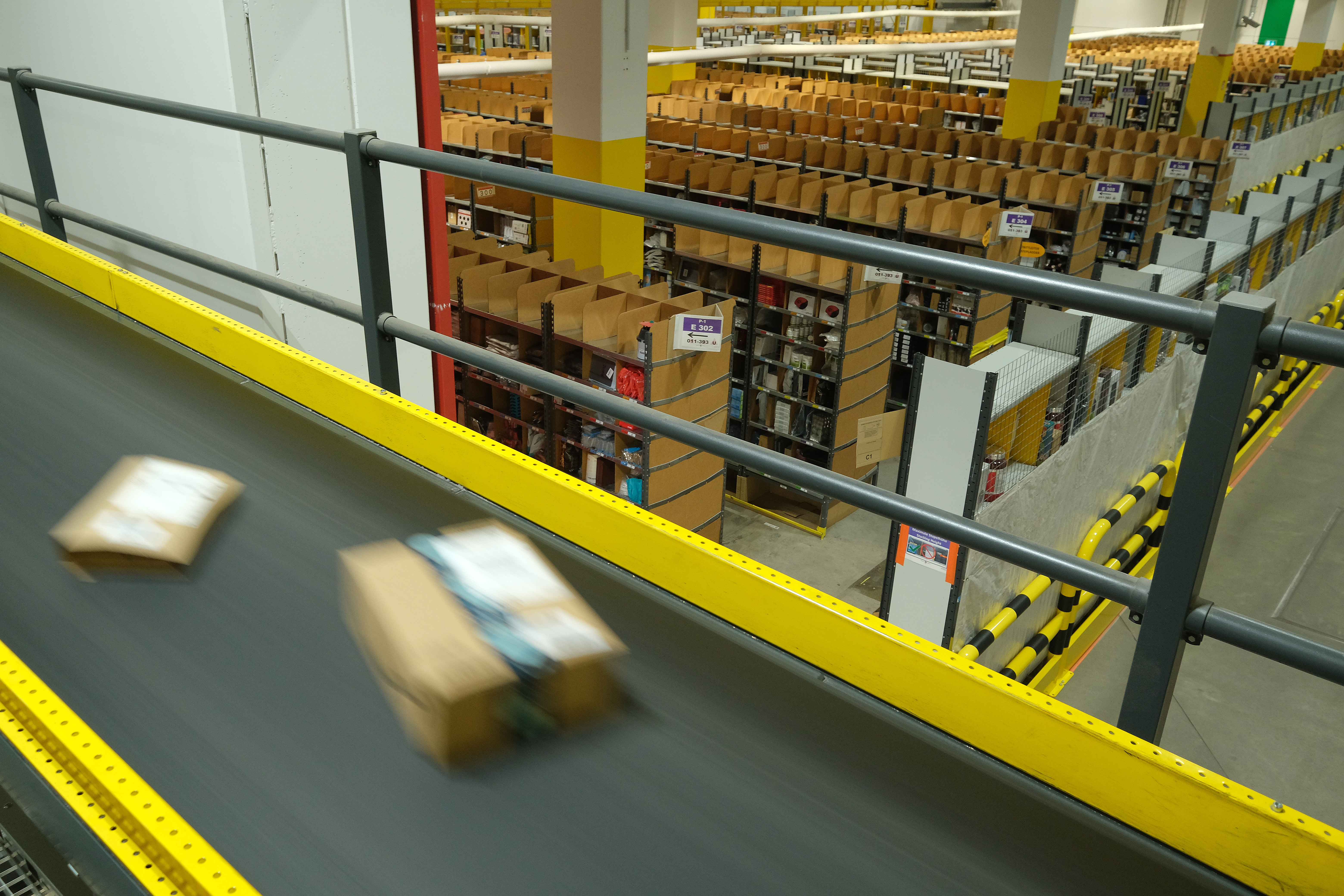 Packages flow along a conveyor belt at an Amazon packaging center on Nov. 28, 2019 in Brieselang, Germany. (Credit: Sean Gallup/Getty Images)