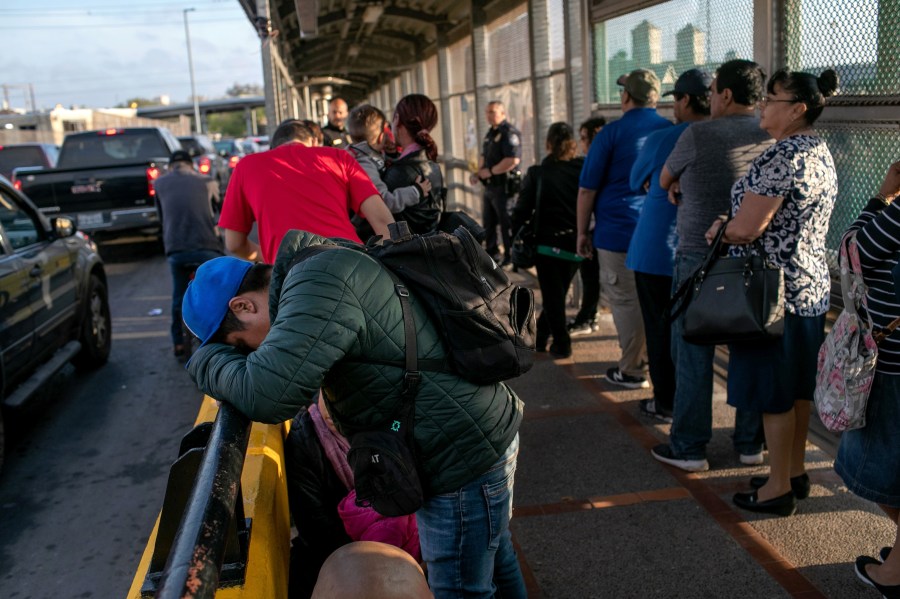 A Mexican asylum seeker waits with his family on the international bridge from Mexico to the United States on Dec. 09, 2019, next to the border town of Matamoros, Mexico. (Credit: John Moore/Getty Images)