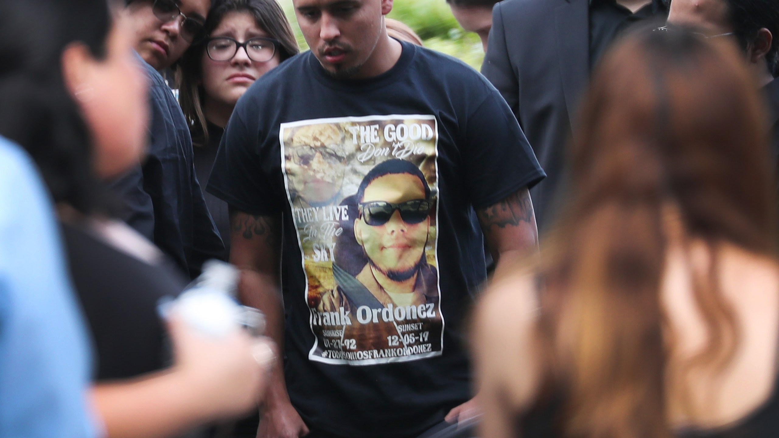 Mourners gather as Frank Ordonez, the UPS driver killed during a shootout between police and two armed robbery suspects, is laid to rest at the Vista Memorial Gardens cemetery on December 10, 2019 in Miami Lakes, Florida. (Credit: Joe Raedle/Getty Images)