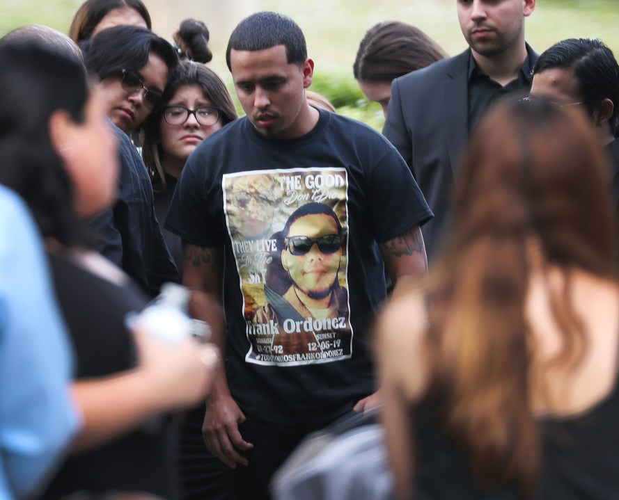 Mourners gather as Frank Ordonez, the UPS driver killed during a shootout between police and two armed robbery suspects, is laid to rest at the Vista Memorial Gardens cemetery on December 10, 2019 in Miami Lakes, Florida. (Credit: Joe Raedle/Getty Images)