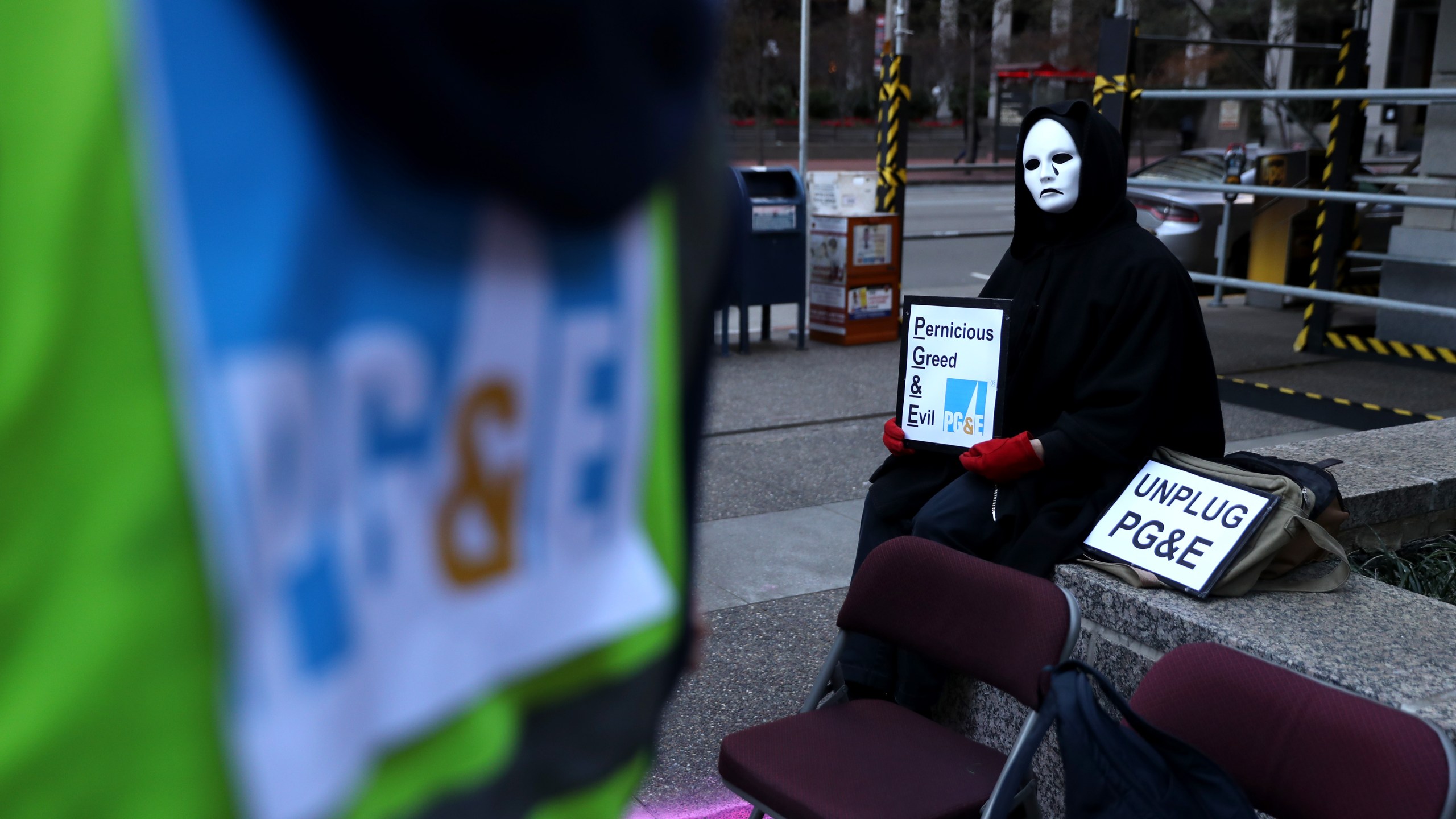 A protester holds a sign during a demonstration outside of Pacific Gas & Electric offices in San Francisco on Dec. 16, 2019. (Credit: Justin Sullivan / Getty Images)