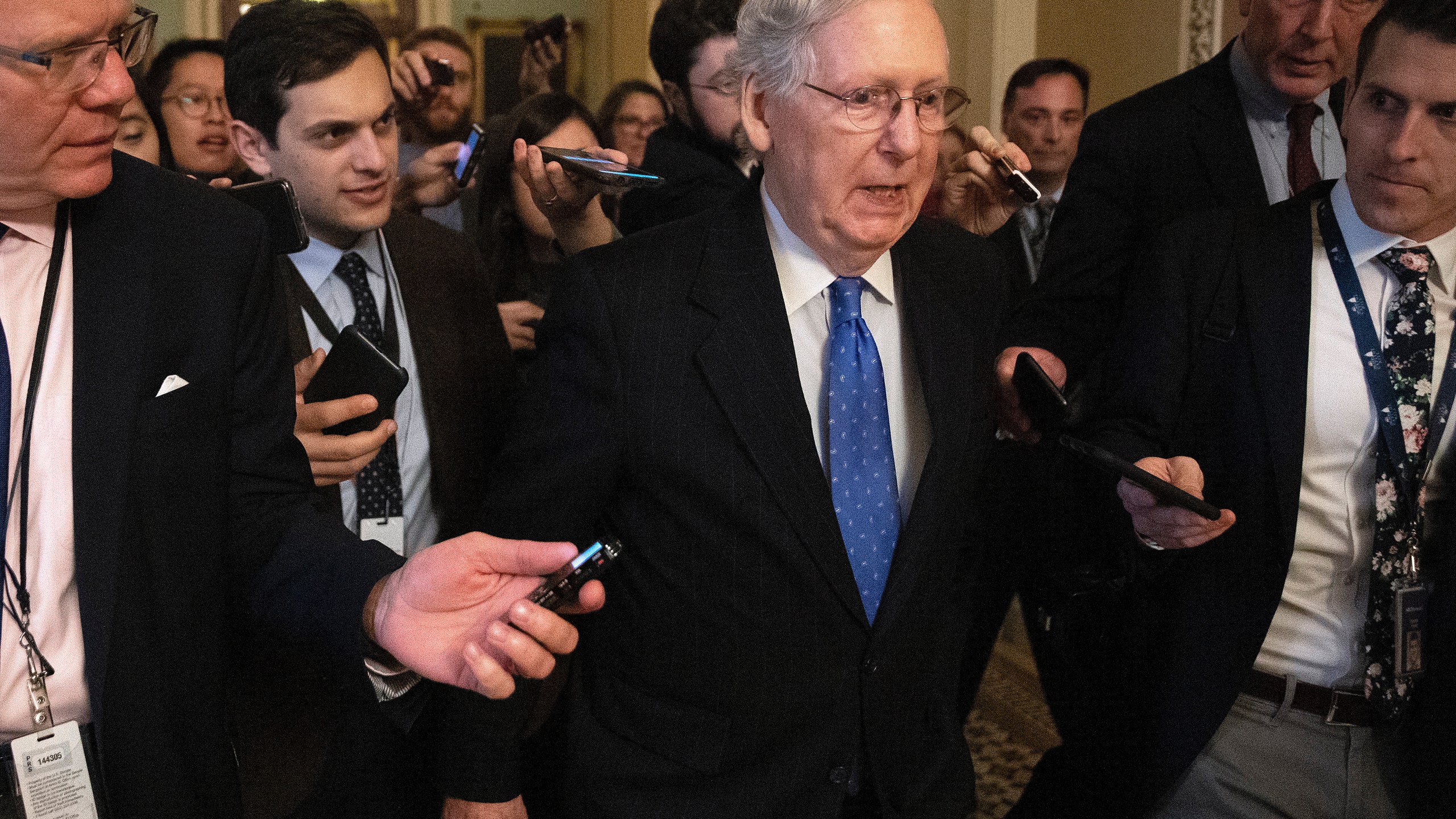 Senate Majority Leader Mitch McConnell (R-KY) is surrounded by journalists as he walks back to his office in the U.S. Capitol on Dec. 19, 2019, in Washington, D.C. The Senate passed legislation funding the federal government through the next fiscal year before leaving for the holiday break. (Credit: Chip Somodevilla/Getty Images)