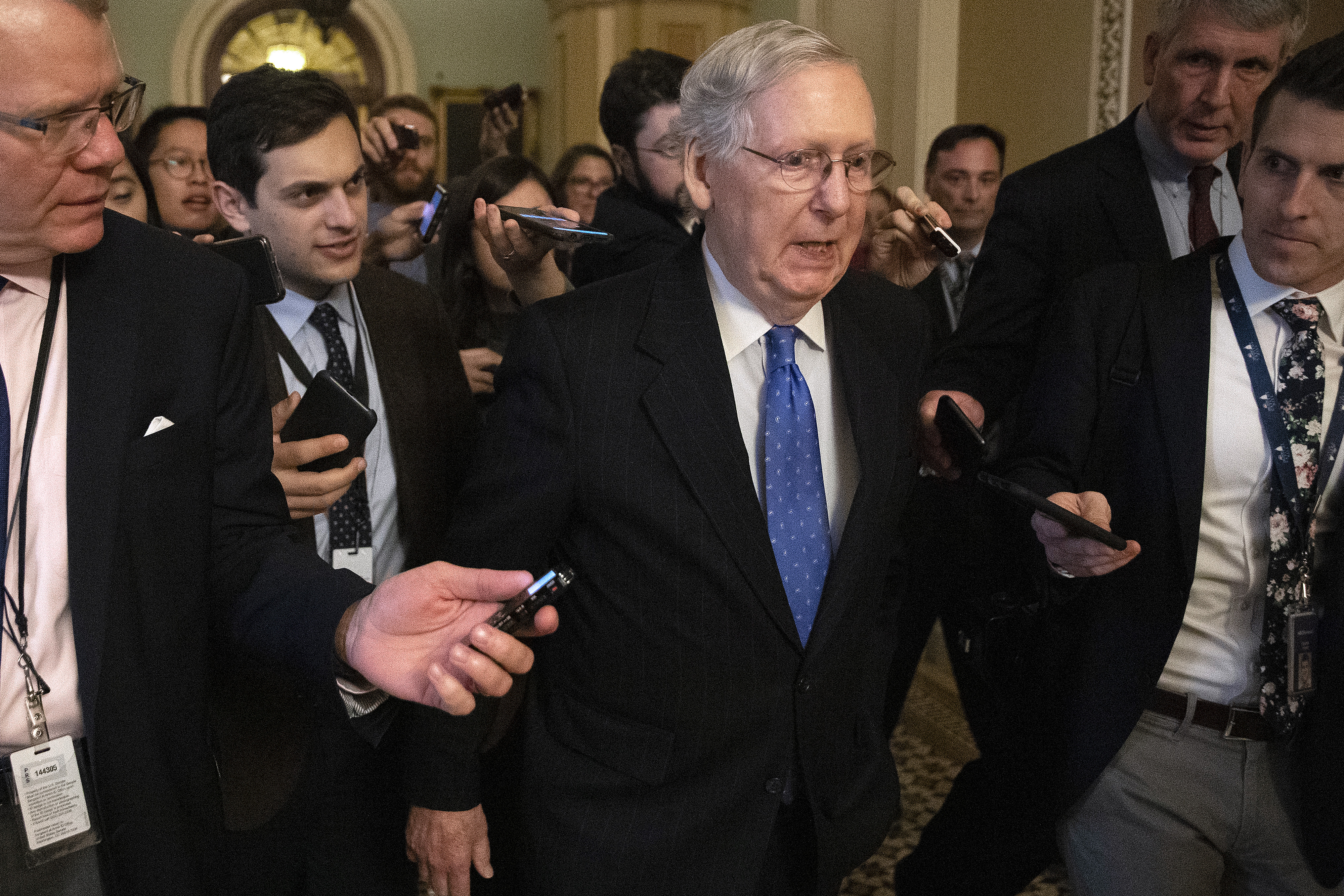 Senate Majority Leader Mitch McConnell (R-KY) is surrounded by journalists as he walks back to his office in the U.S. Capitol on Dec. 19, 2019, in Washington, D.C. The Senate passed legislation funding the federal government through the next fiscal year before leaving for the holiday break. (Credit: Chip Somodevilla/Getty Images)