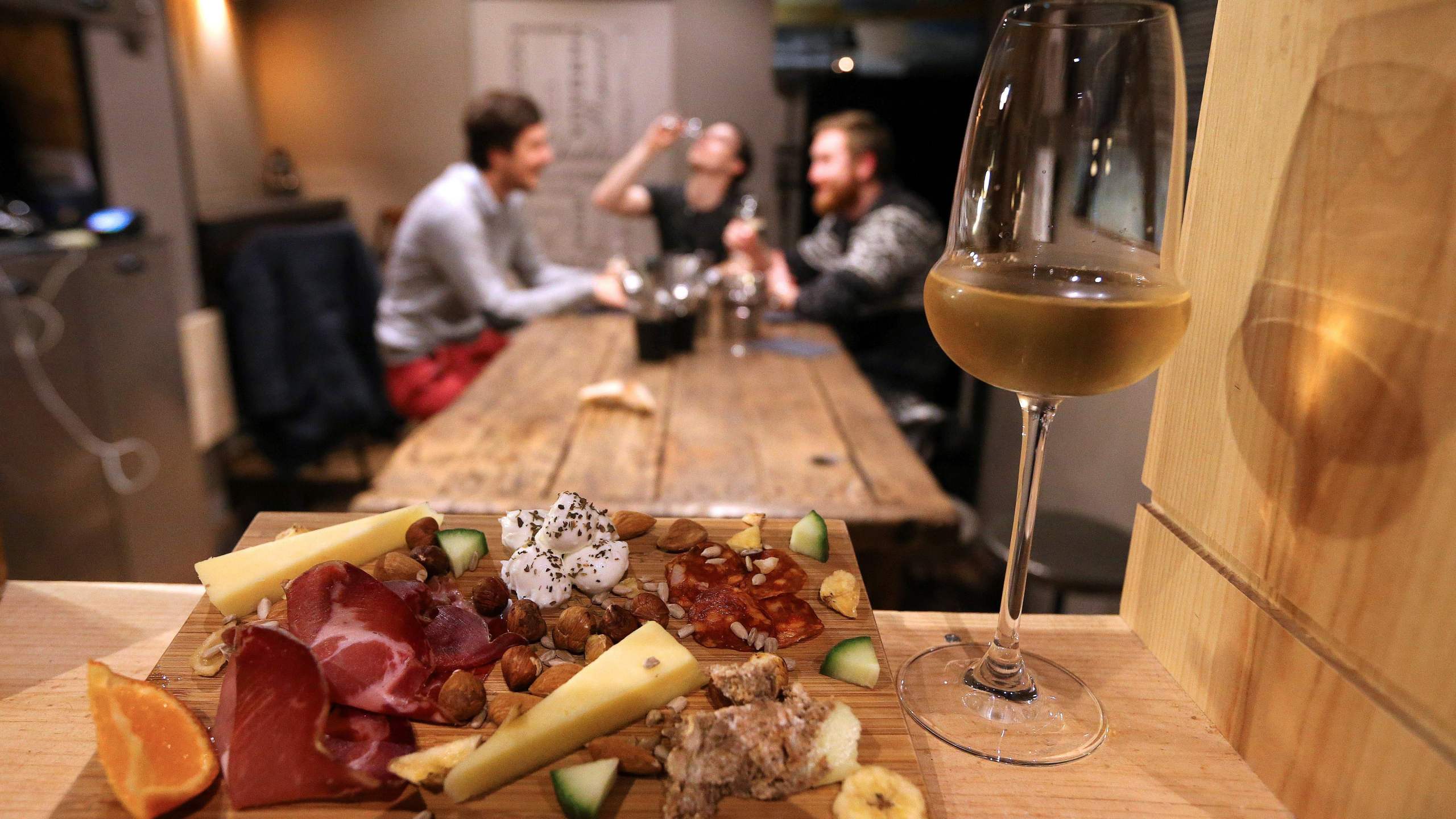 A glass of champagne is served with cheese and ham in Reims, northeastern France, on Dec. 20, 2016. (Credit: FRANCOIS NASCIMBENI/AFP via Getty Images)