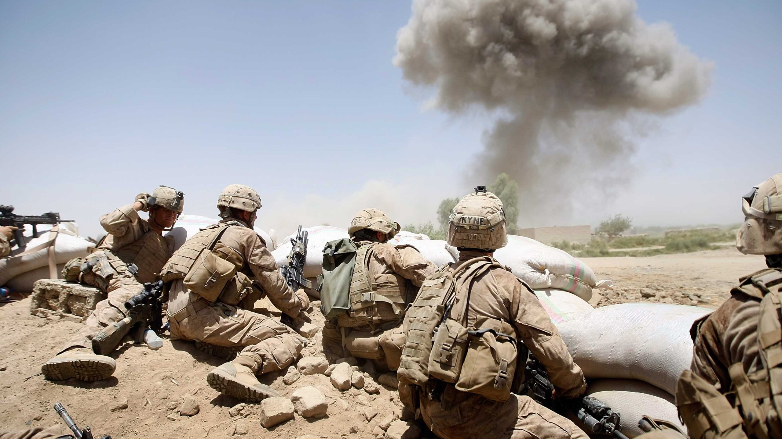 U.S. Marines take cover as a bomb explodes on a compound on July 3, 2009 in Main Poshteh, Afghanistan. (Credit: Joe Raedle/Getty Images)