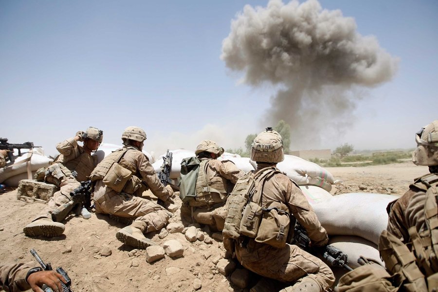 U.S. Marines take cover as a bomb explodes on a compound on July 3, 2009 in Main Poshteh, Afghanistan. (Credit: Joe Raedle/Getty Images)