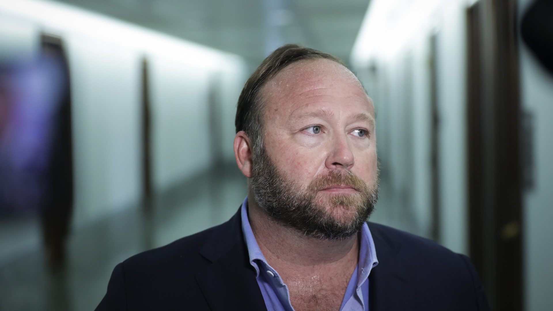 Alex Jones of InfoWars talks to reporters outside a Senate Intelligence Committee hearing concerning foreign influence operations' use of social media platforms, on Capitol Hill on Sept. 5, 2018. (Credit: Drew Angerer/Getty Images)