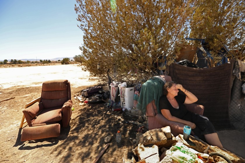 Roberta Massie sits in a chair at her encampment in Lancaster. L.A. Family Housing was able to find her housing in October 2018. (Credit: Genaro Molina / Los Angeles Times)