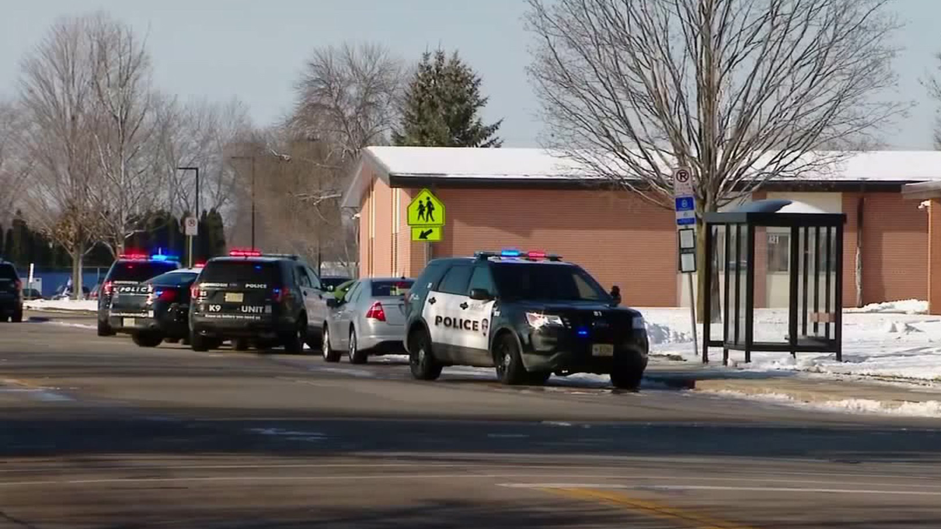 Police vehicles are seen outside Oshkosh West High School in Oshkosh, Wisconsin, on Dec. 3, 2019. (Credit: WITI)