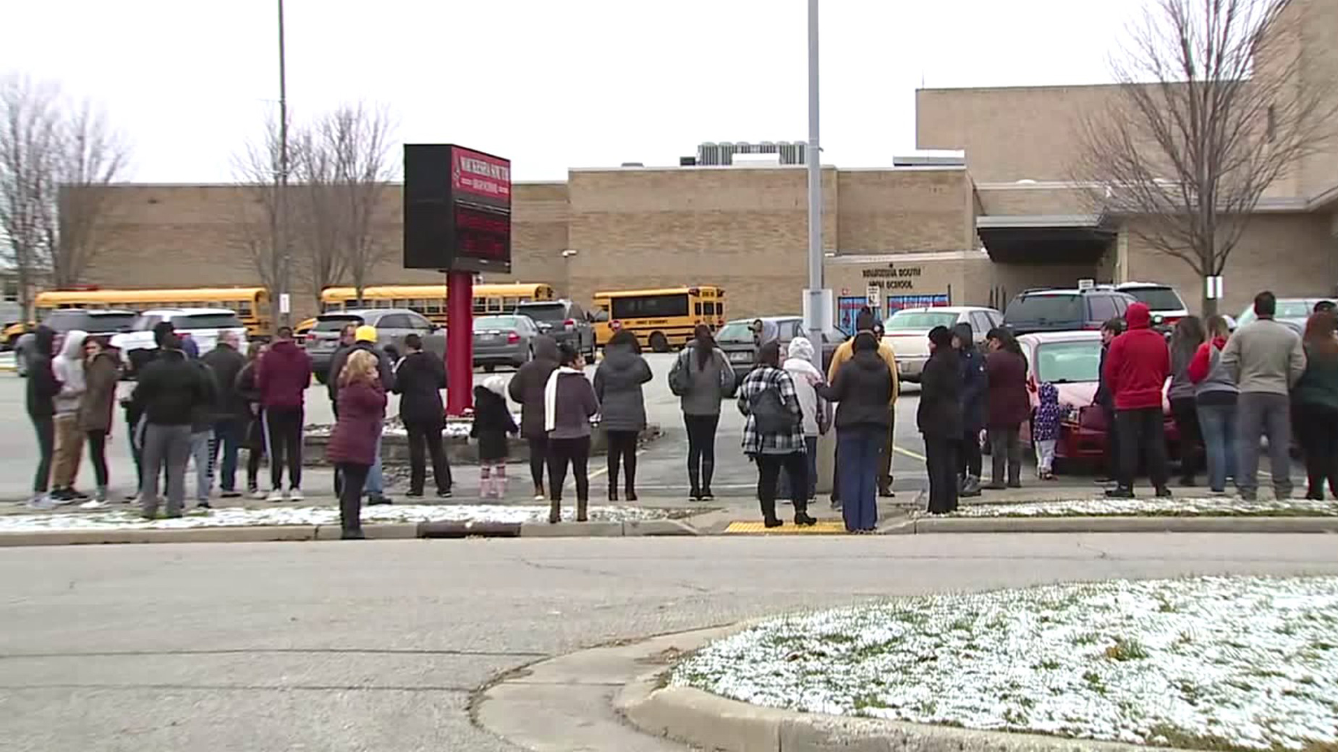 Students and parents stand outside Waukesha South High School after a shooting on campus on Dec. 2, 2019. (Credit: WITI)