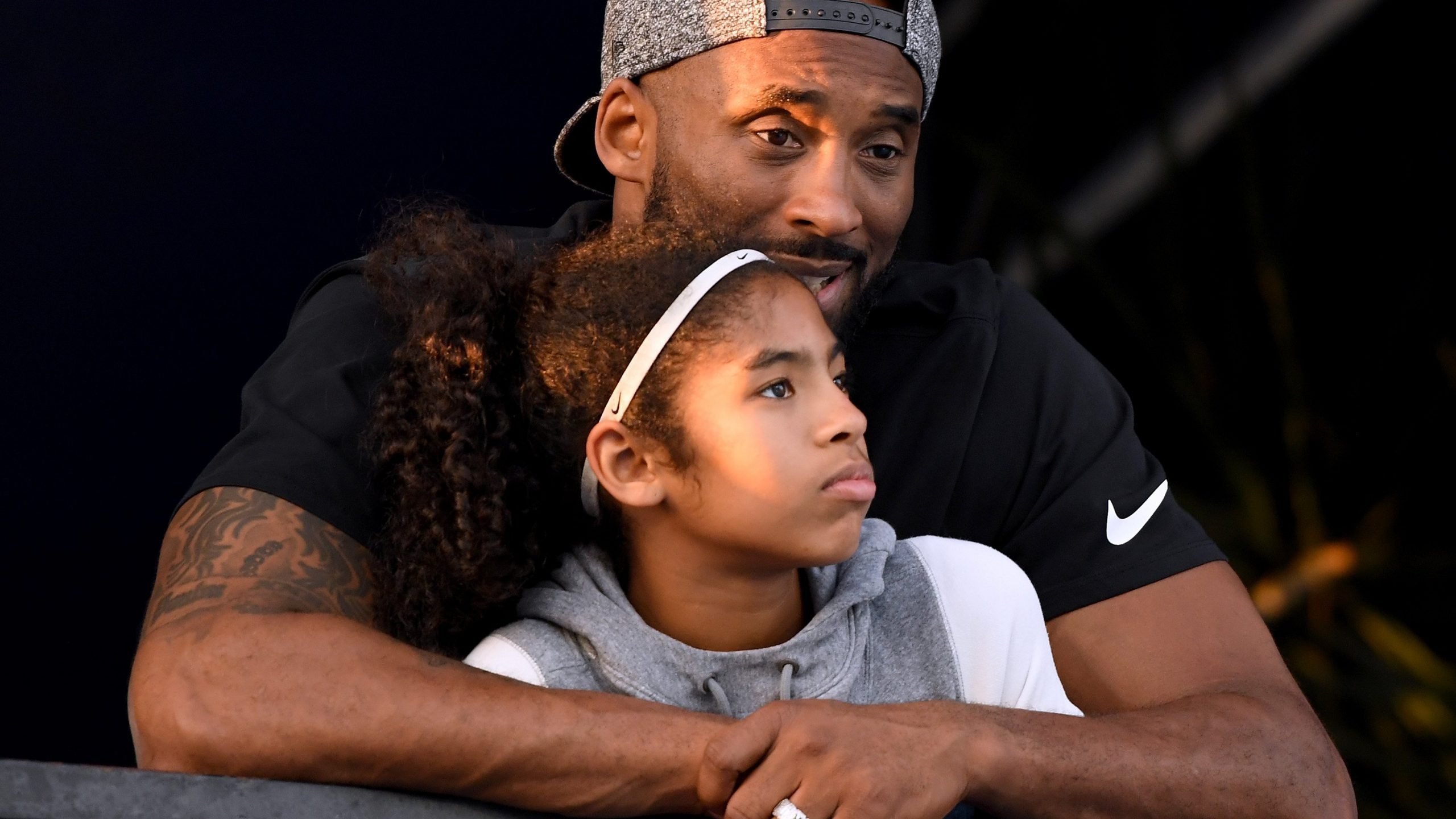 Kobe Bryant and daughter Gianna Bryant watch the Phillips 66 National Swimming Championships at the Woollett Aquatics Center on July 26, 2018, in Irvine. (Photo by Harry How/Getty Images)