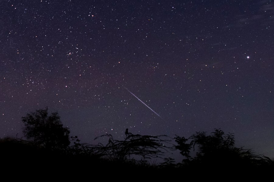 This photo taken late December 14, 2018 with a long time exposure shows a meteor streaking through the night sky over Myanmar during the Geminid meteor shower seen from Wundwin township near Mandalay city. (Credit: YE AUNG THU/AFP via Getty Images)