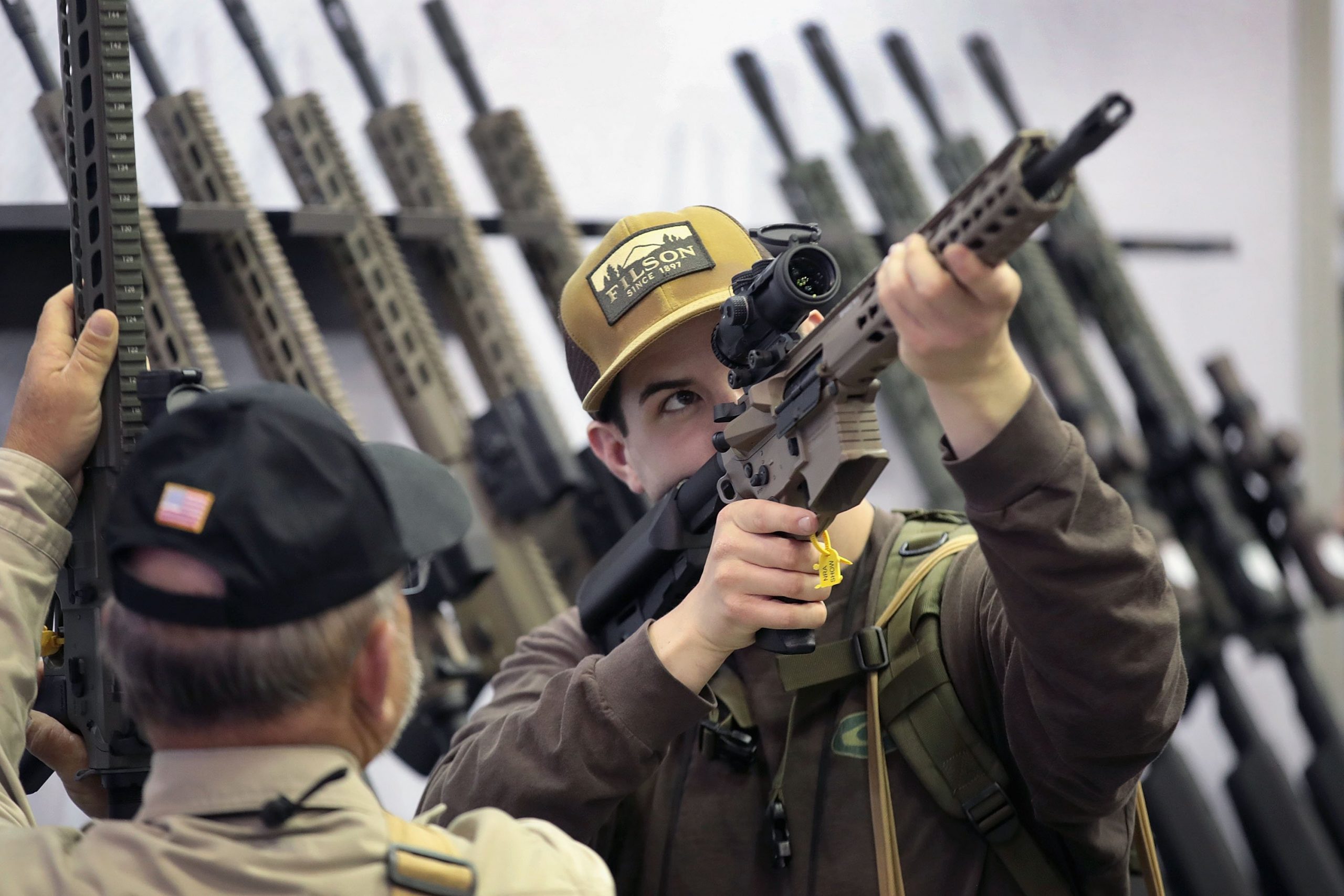 Guests look over rifle scopes at the 148th NRA Annual Meetings and Exhibits on April 27, 2019, in Indianapolis, Indiana. (Credit: Scott Olson/Getty Images)